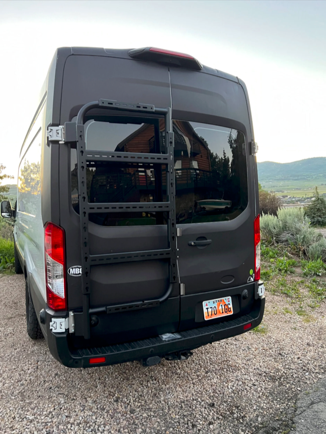 Avatar Offroad Avatar Massif Van Rear Door Storage Mounting System installed on a transit van's rear door, showcasing its durable design.
