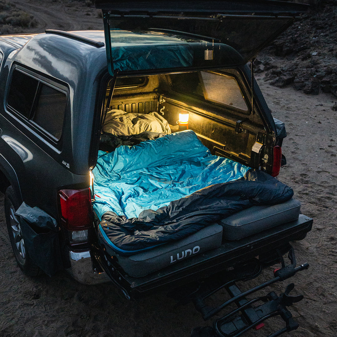 Luno® AIR Truck Bed Mattress fitted in a mid-size truck bed, showcasing its durable fabric and comfortable design.