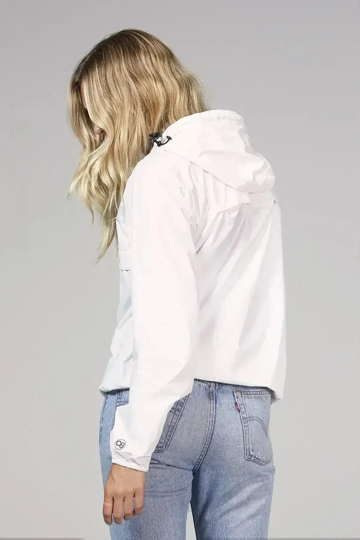 White Femstylo quarter zip packable rain jacket and windbreaker, back view showing lightweight, waterproof design and adjustable hood.
