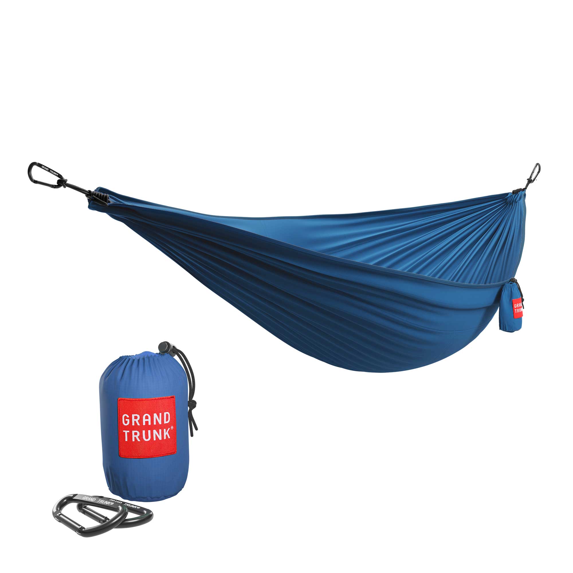 Blue GrandTrunk ultralight starter hammock set up in a natural outdoor setting, showcasing its lightweight design.