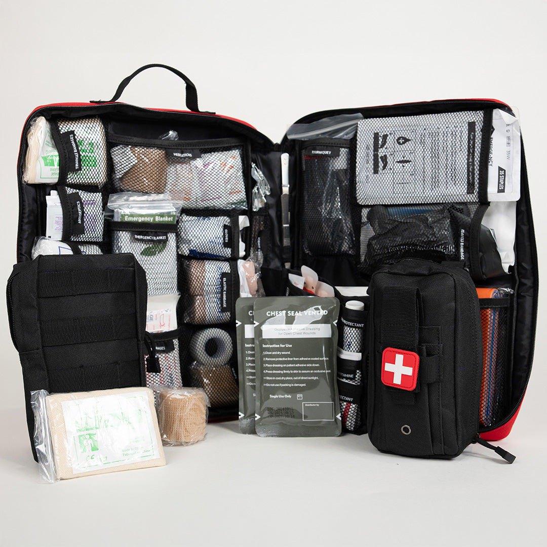 Open image of Emerge Survival Ultimate Survival Med Kit showing various first aid supplies inside a compact case.