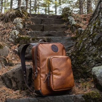 Backcountry Sportsman Bison Leather Standard Backpack in large size, shown outdoors with straps and leather details.