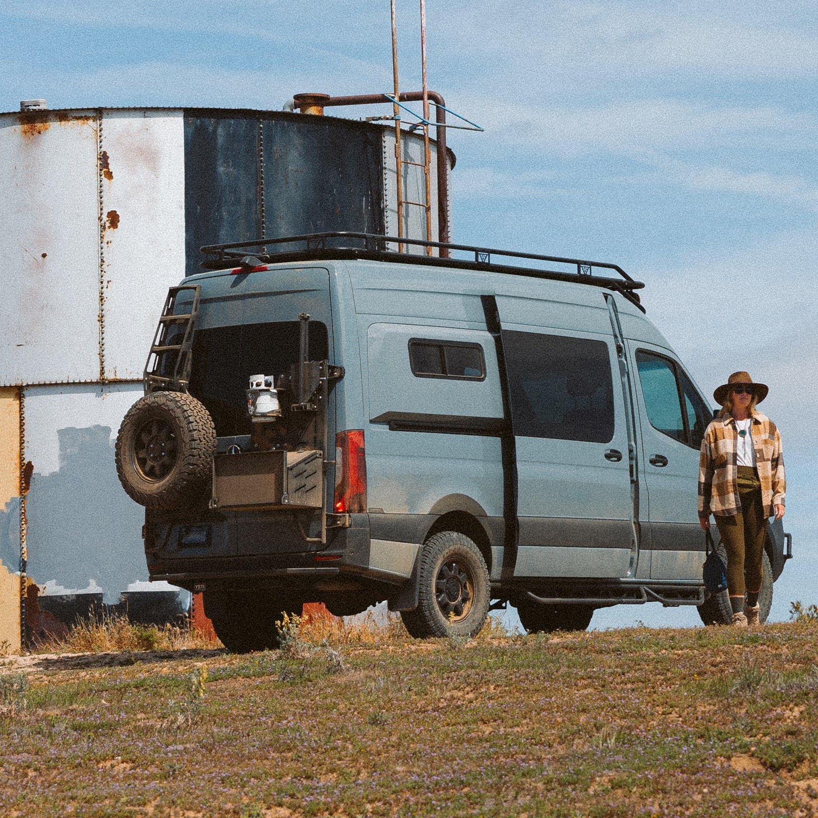 Vanspeed Sprinter rear tire carrier mounted on van exterior, durable metal construction with secure mounting brackets