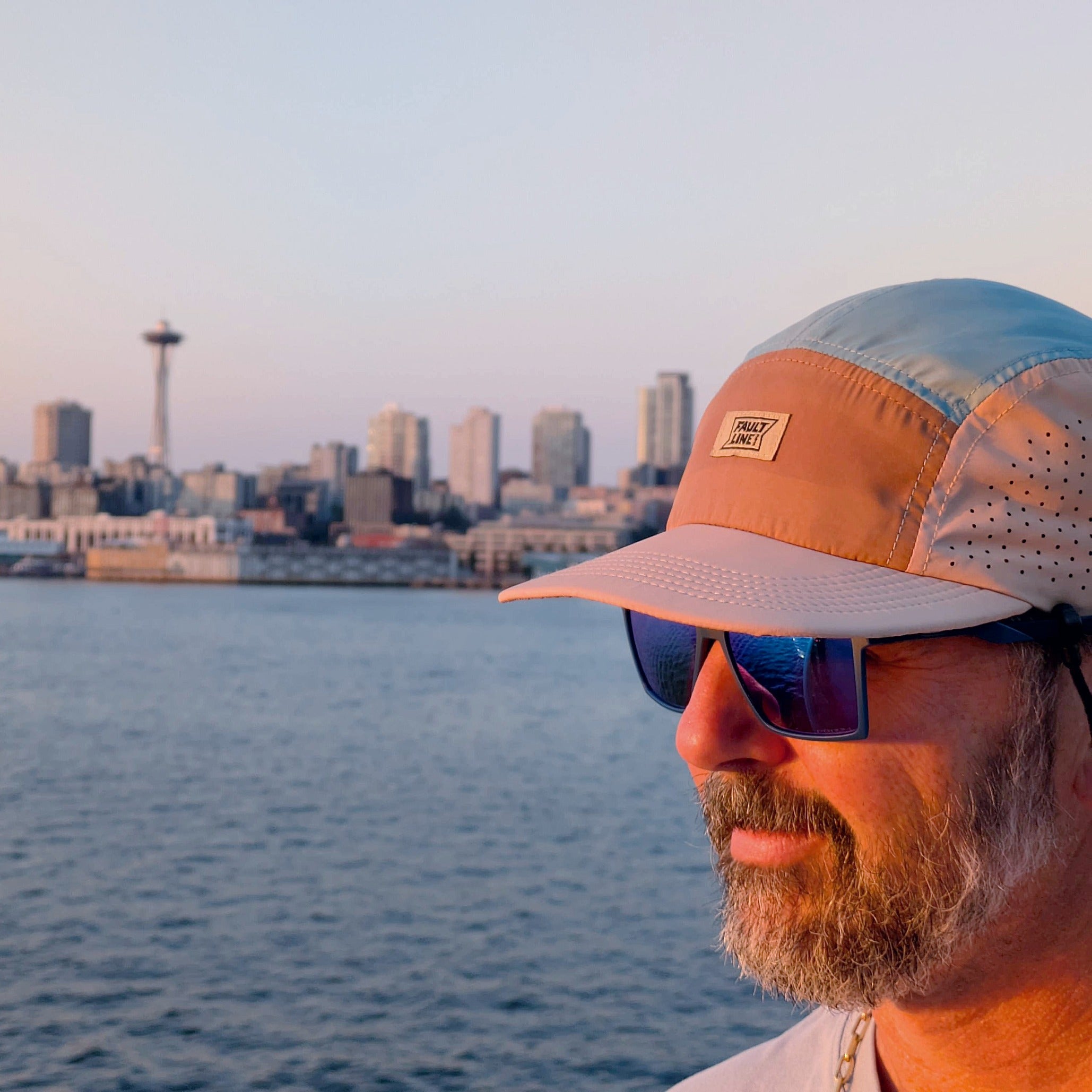 Faultline395 crushable 5-panel camper hat in tan and teal with a relaxed brim and adjustable strap for casual outdoor wear.