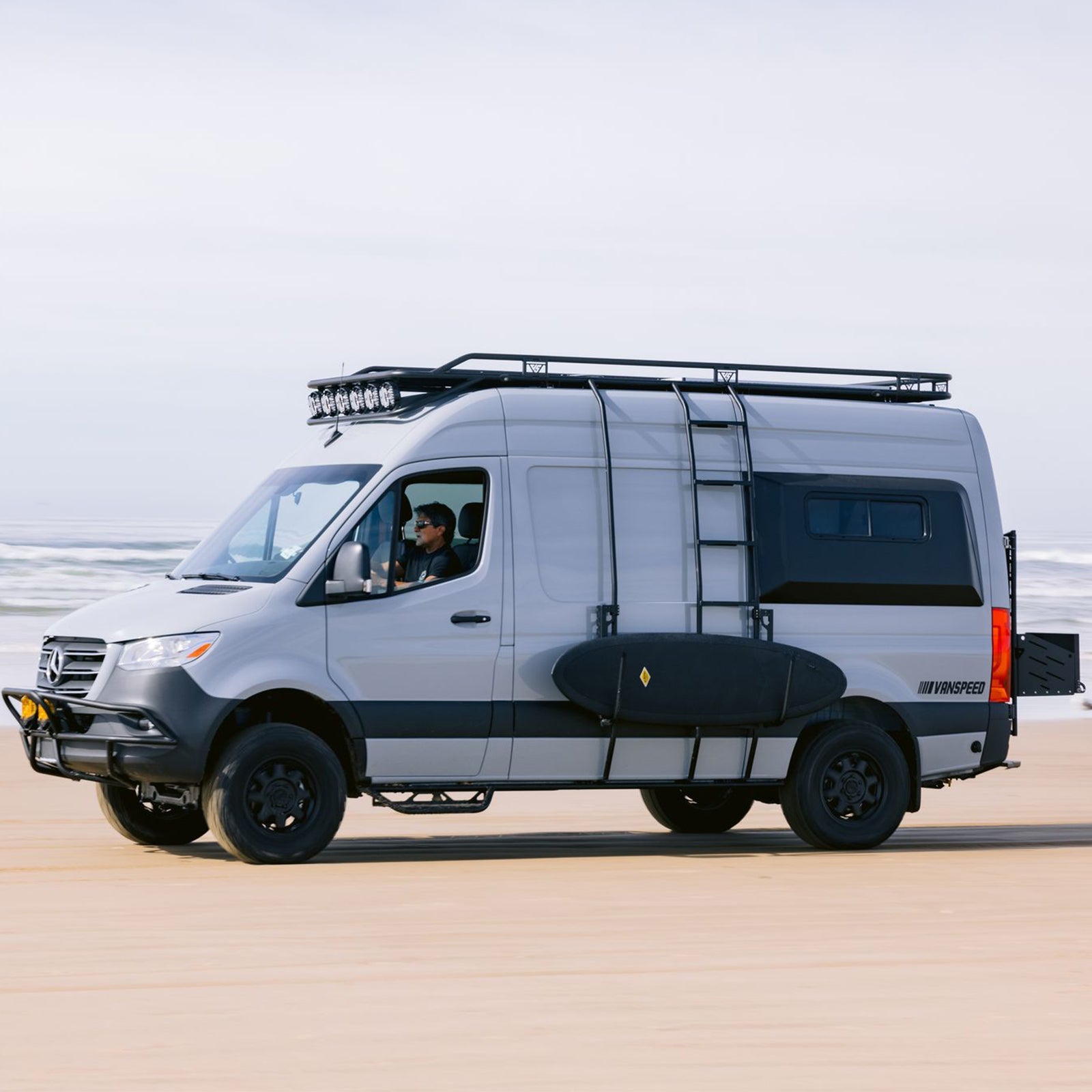 Sprinter Exterior Surf Rack Set by The Van Mart, showcasing a durable rack mounted on a van for carrying surfboards.