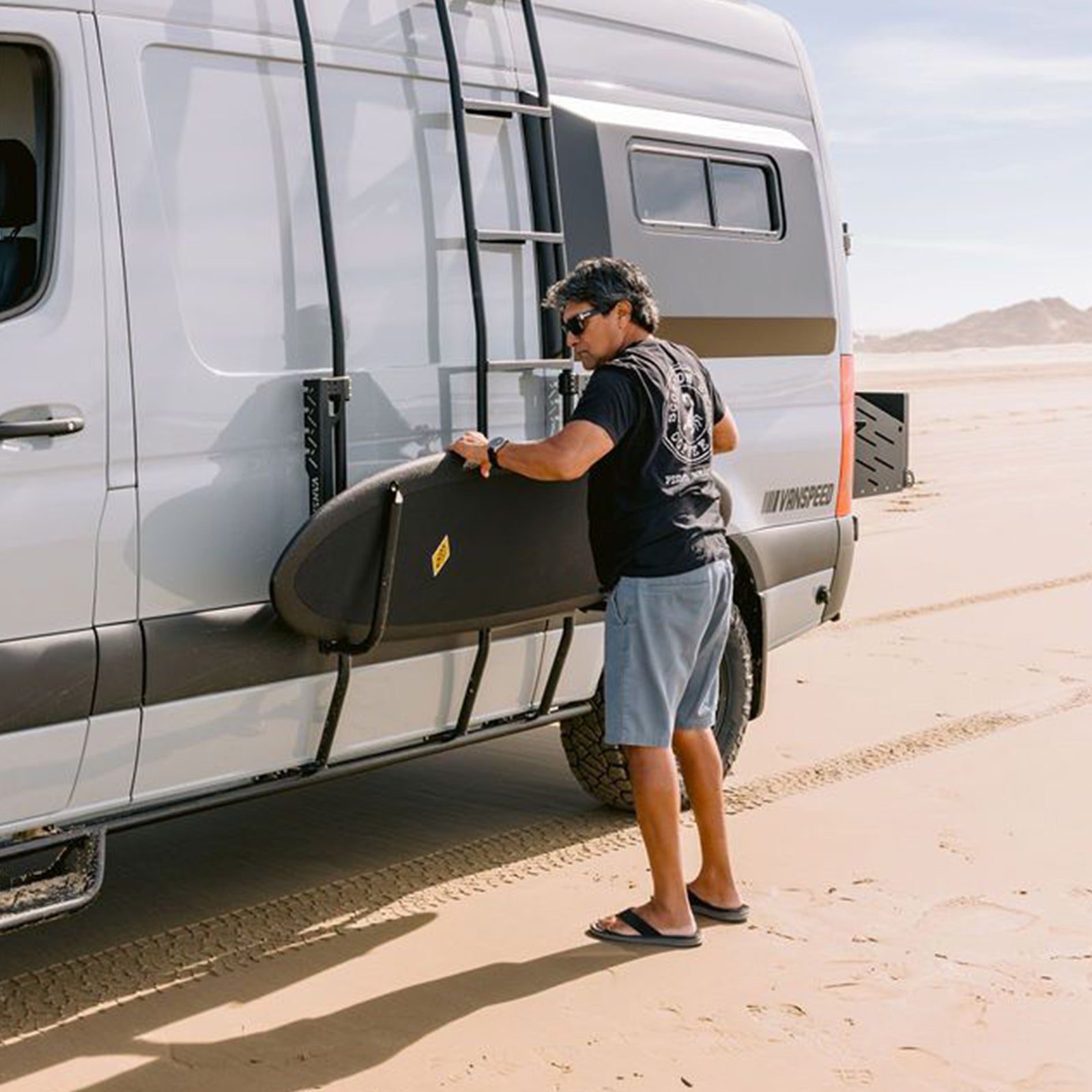Sprinter Exterior Surf Rack Set by The Van Mart, featuring sturdy mounts and adjustable arms for secure surfboard transport.