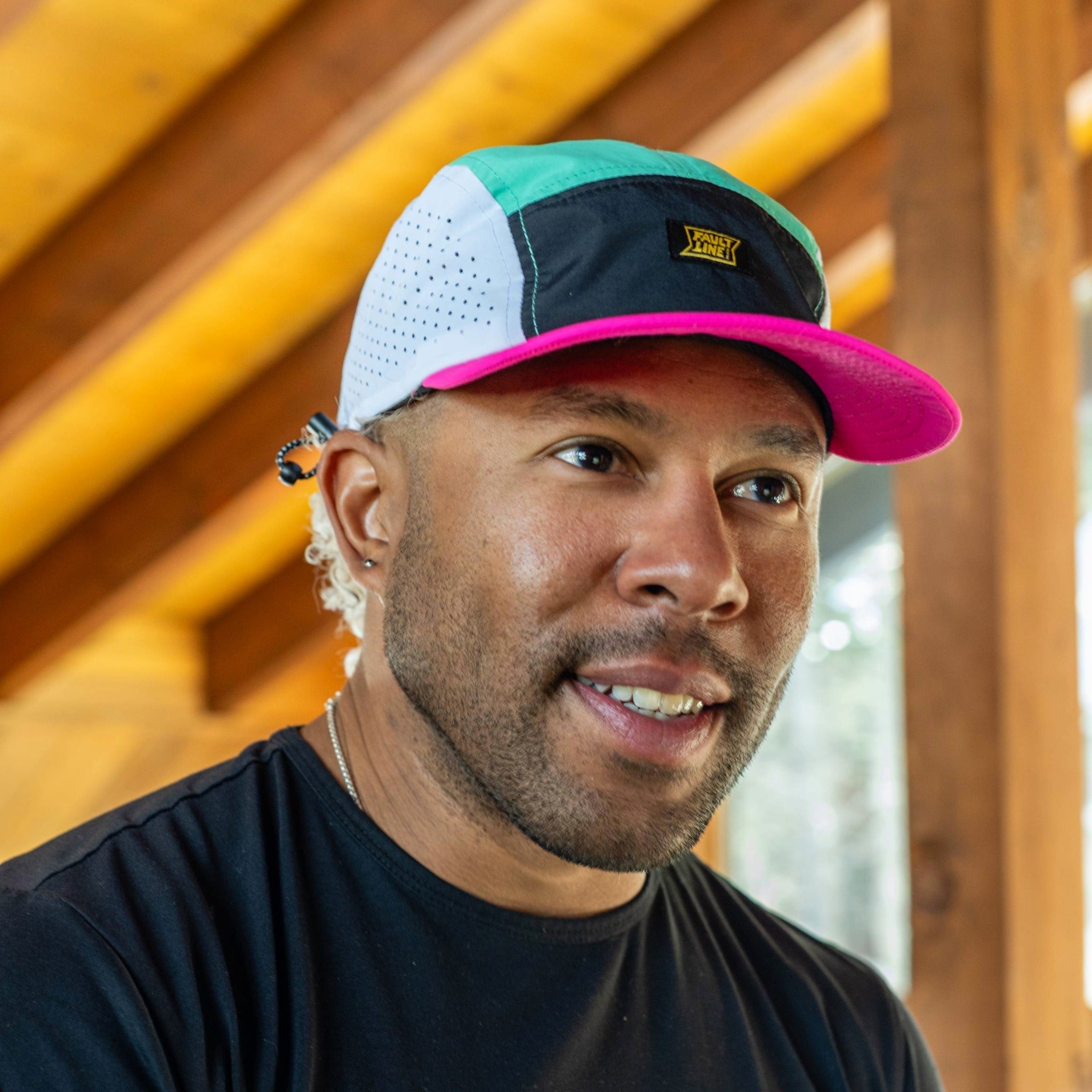 Faultline395 crushable 5-panel camper hat in seafoam and fuchsia with a foldable design and adjustable strap.