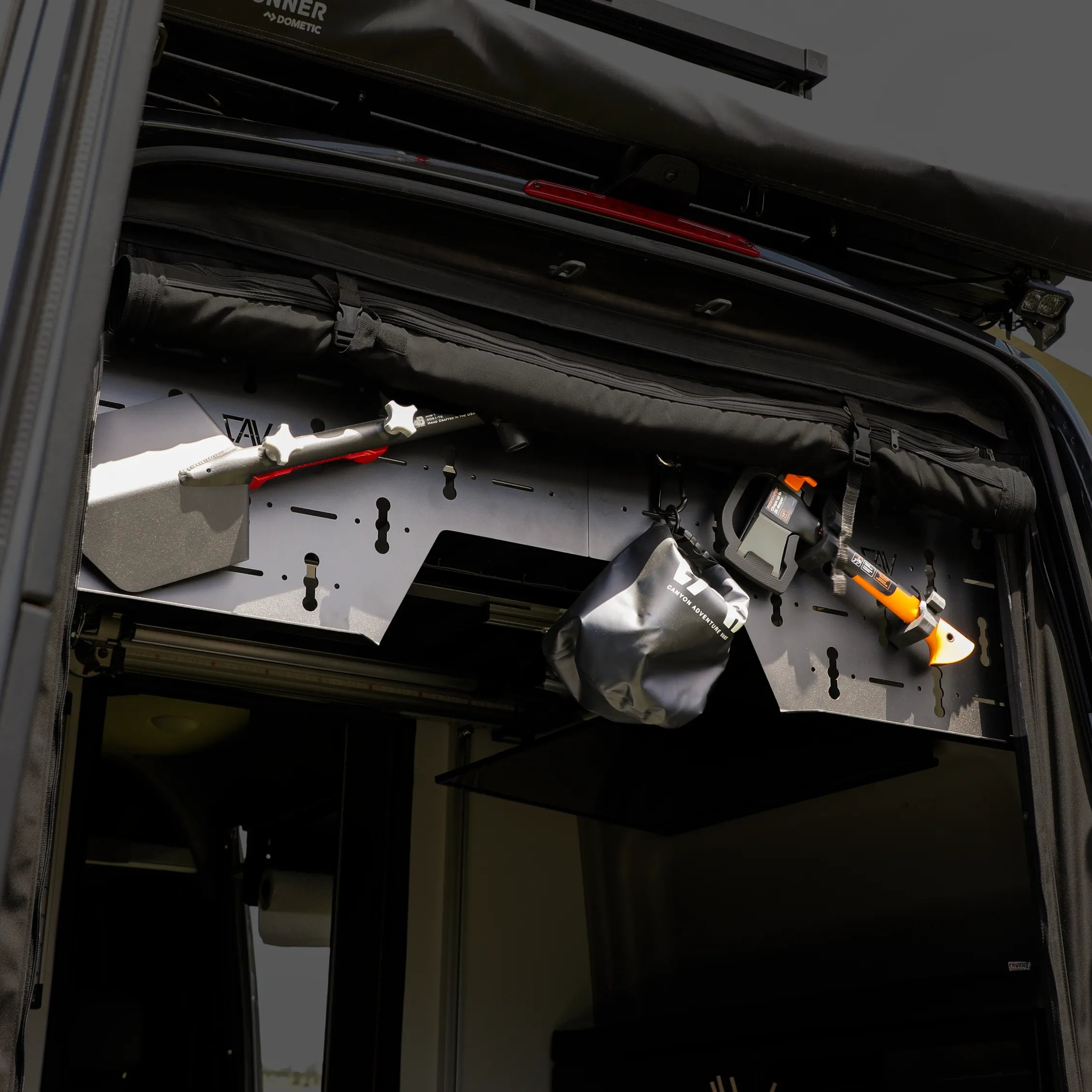 Canyon Adventure Vans CAV branded upper gear panel for Revel models 2021-2024, mounted inside vehicle interior.