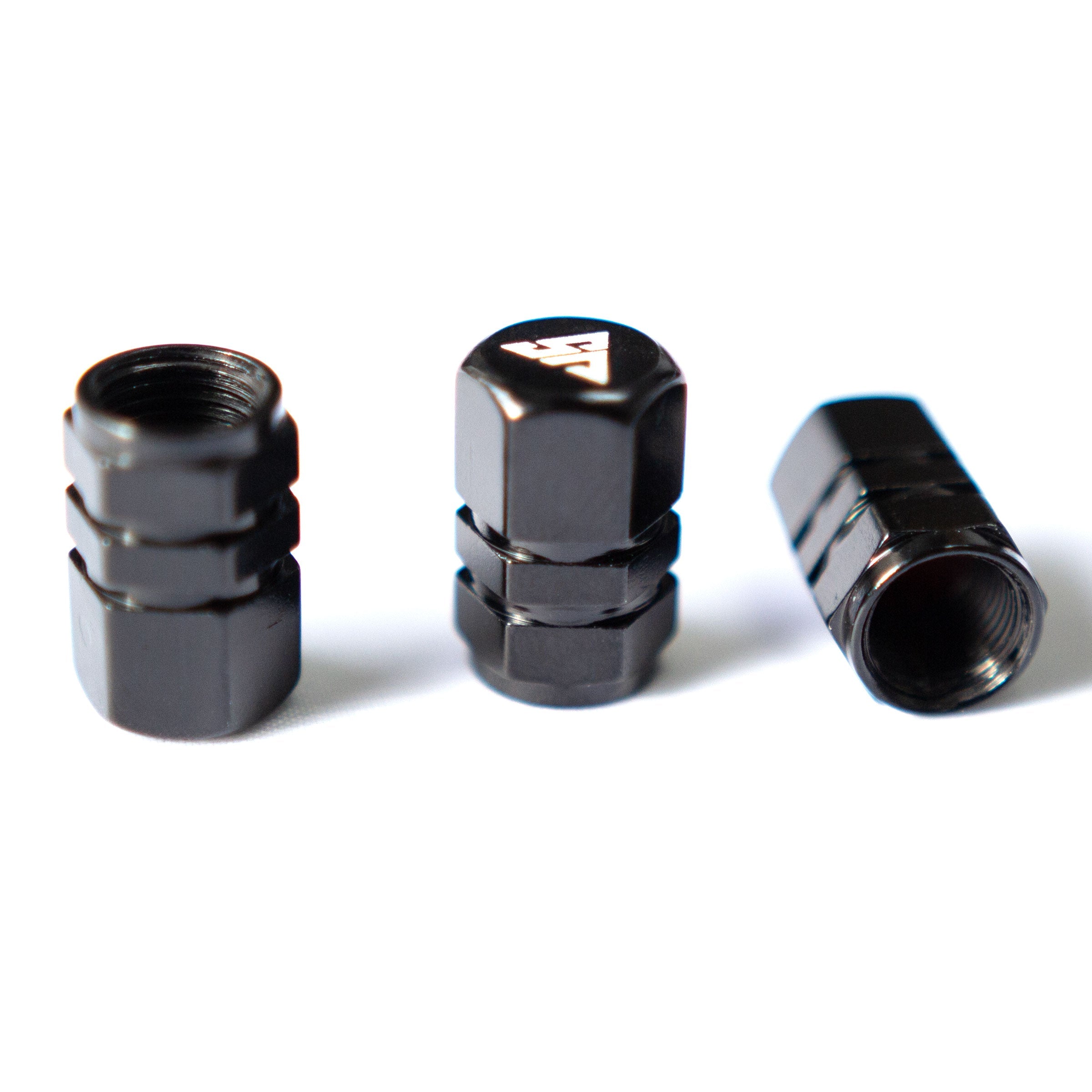 Universal valve stem caps by The Van Mart displayed in a variety of colors and designs on a white background.