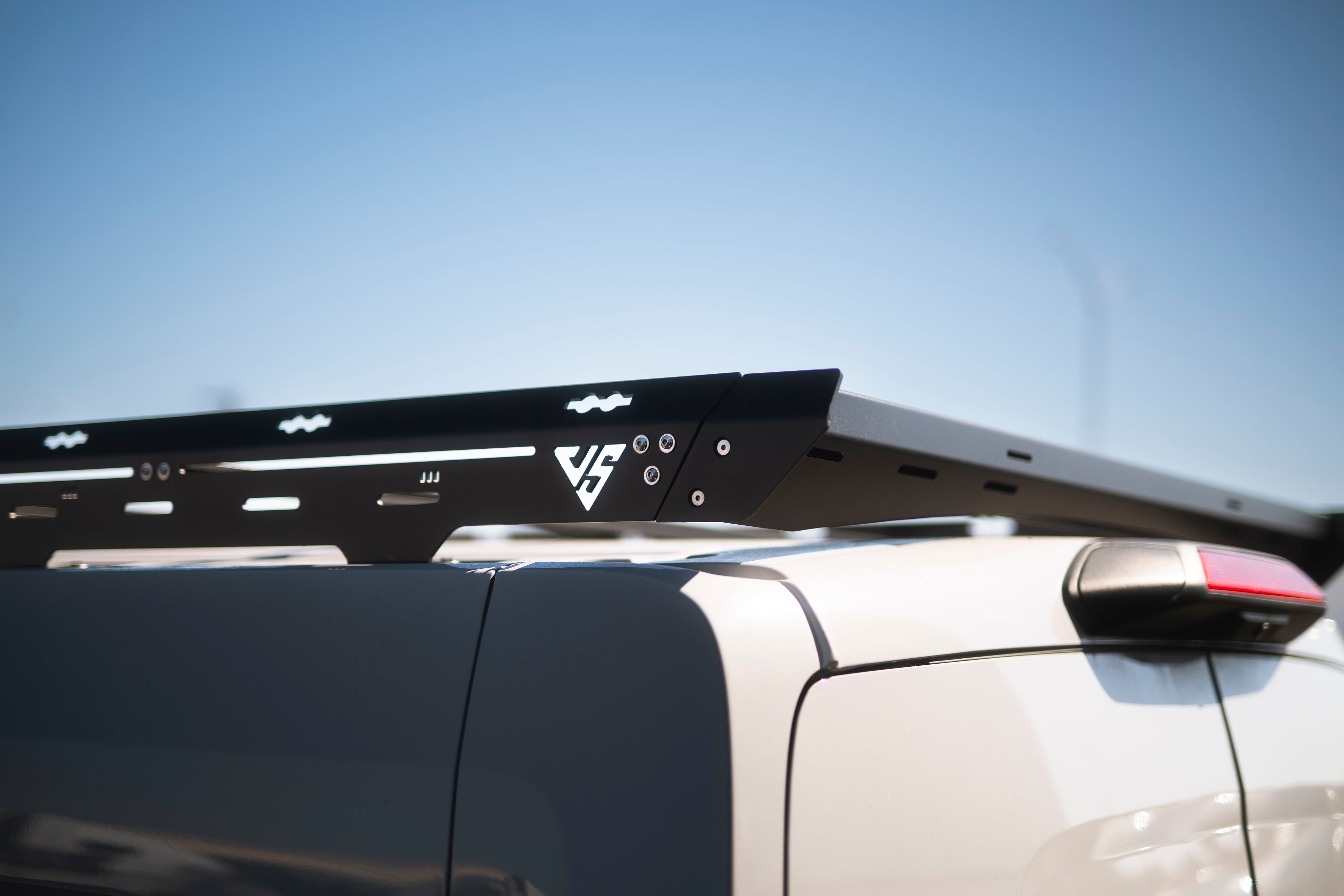 The Van Mart Transit Scout Rack 148 mounted on a vehicle, showcasing its sturdy design and adjustable features.