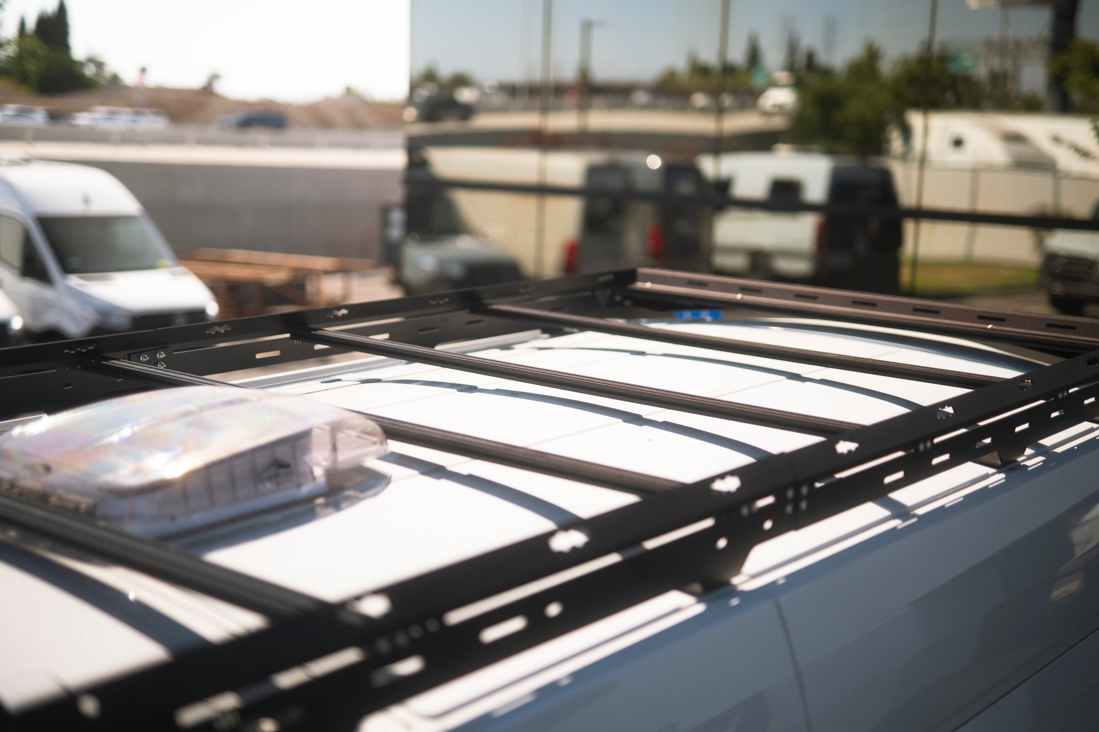 The Van Mart Transit Scout Rack 148 mounted on a vehicle, showcasing its sturdy design and adjustable features.
