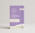 Black vanilla lavender tea from Little Prayer Tea Company in a clear glass teapot with loose tea leaves and dried vanilla and lavender flowers.