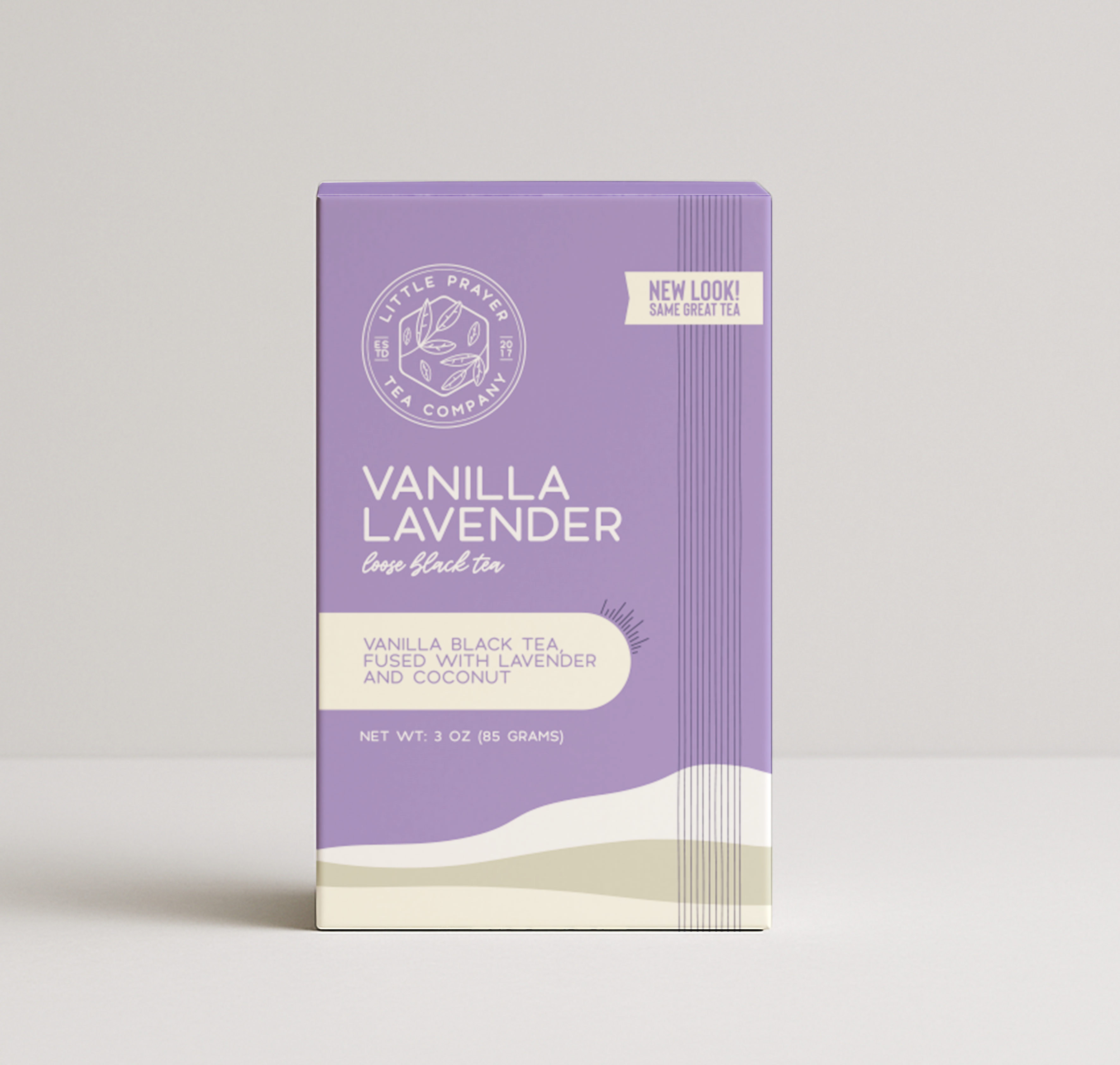 Black vanilla lavender tea from Little Prayer Tea Company in a clear glass teapot with loose tea leaves and dried vanilla and lavender flowers.
