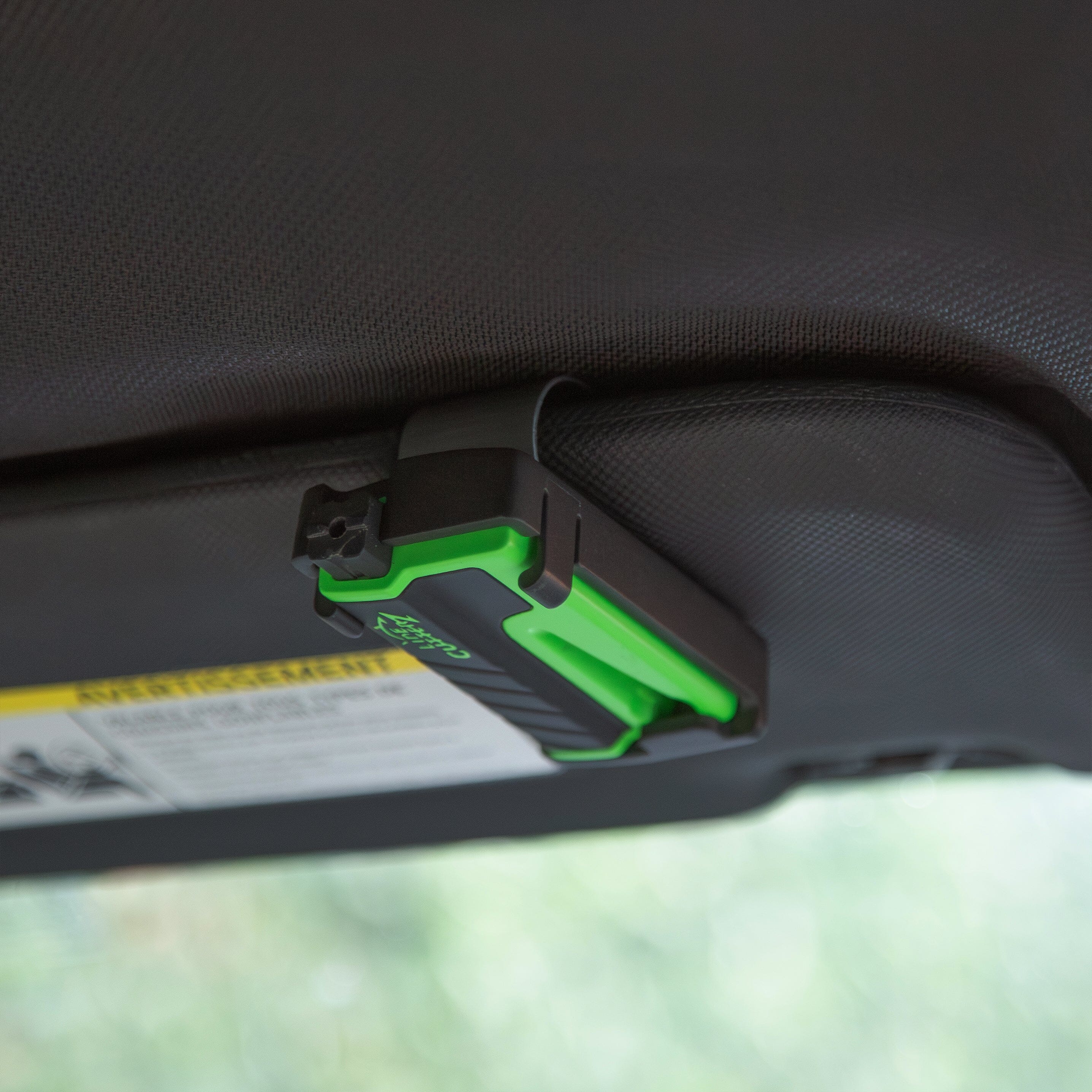 Line Cutterz VET vehicle escape tool clipped to visor, featuring a durable cutter tool for emergency rescue situations.
