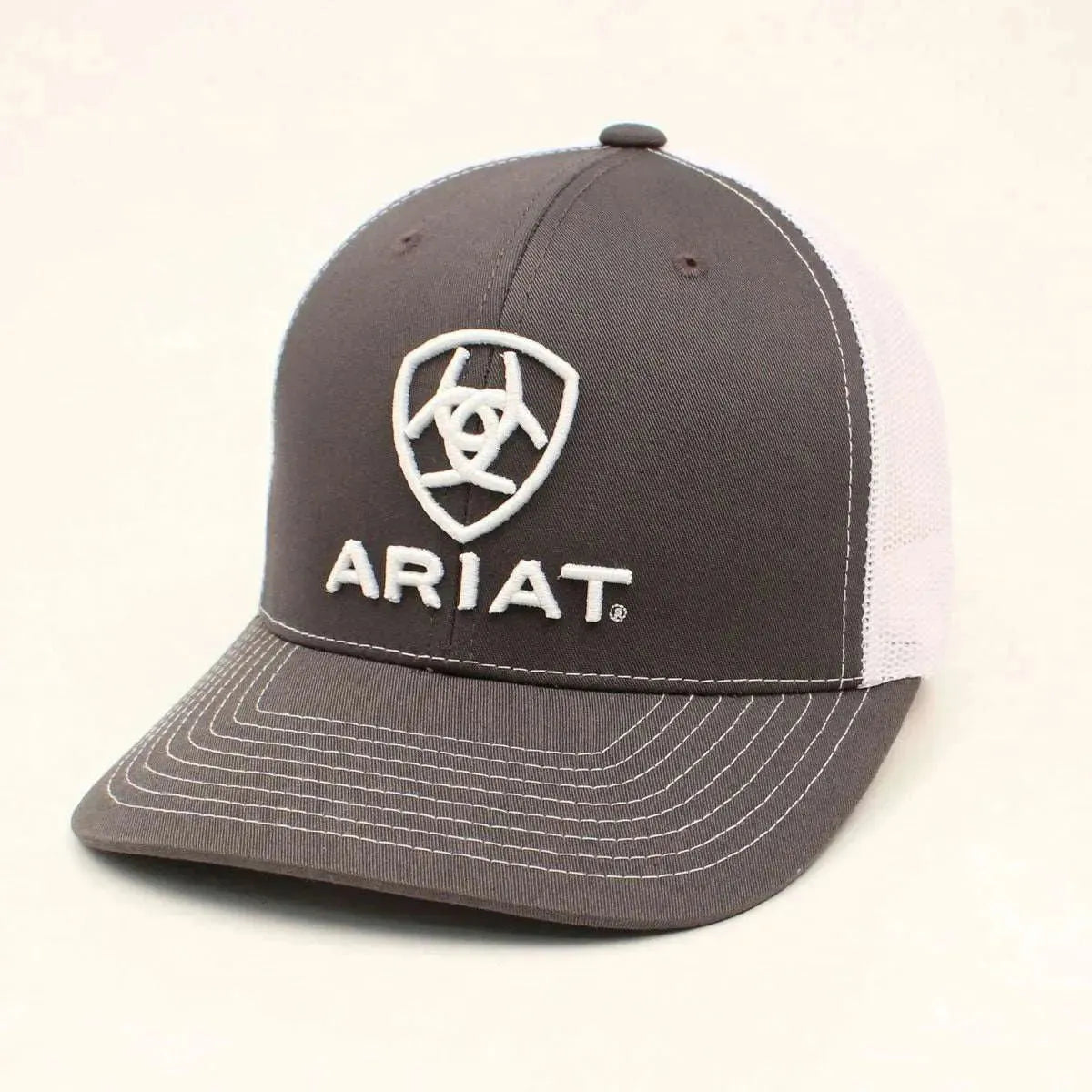 Gray and white Ariat trucker hat with mesh back and curved brim, showcasing casual headwear style.