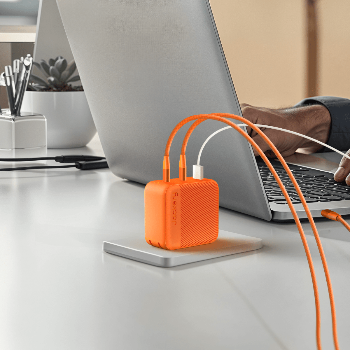 Jackery 102W GaN 3-Port Fast Charger with three USB ports and compact design for efficient charging.