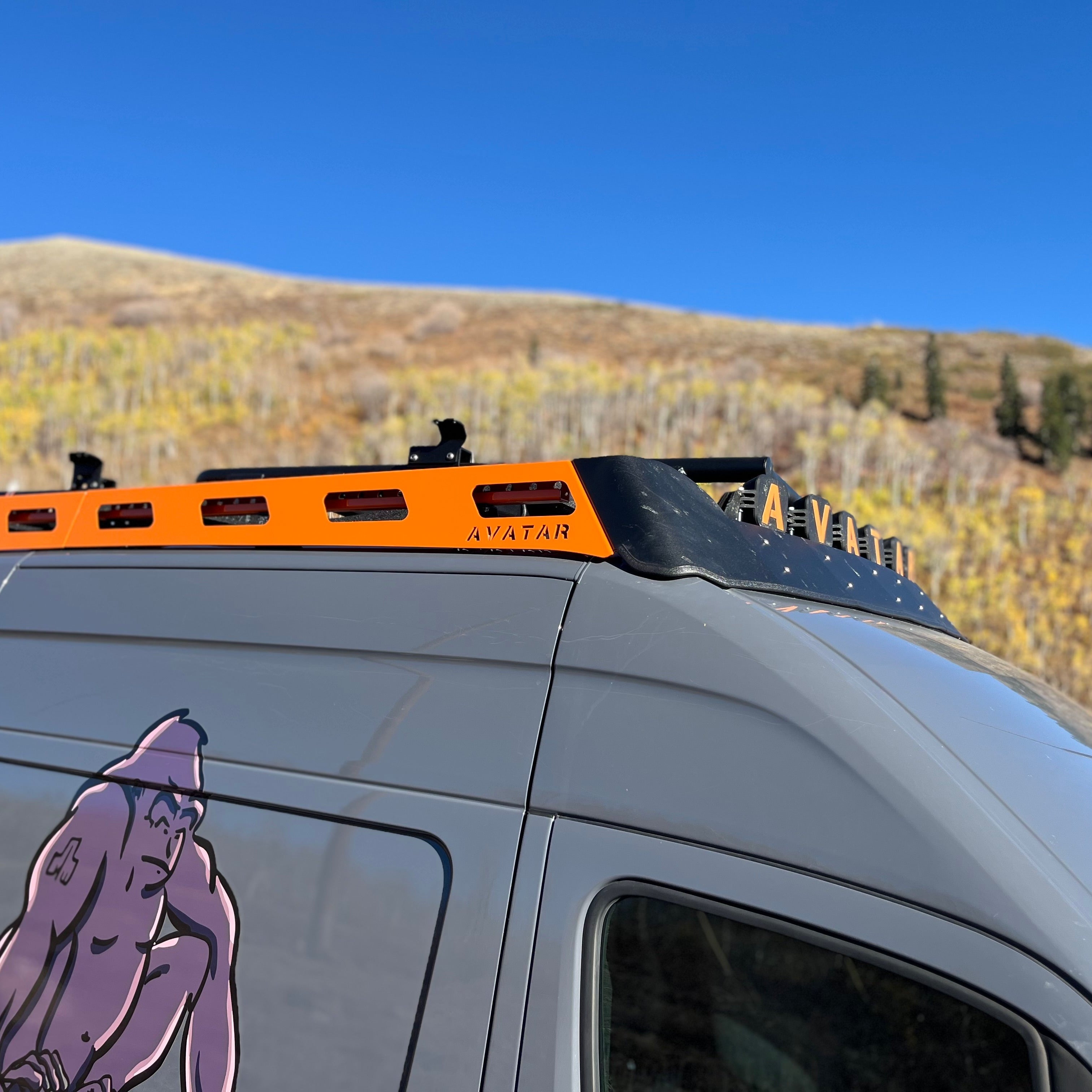 Aerodynamic Pioneer Sprinter roof rack by Avatar Offroad mounted on a vehicle, showcasing its sleek design and sturdy construction.