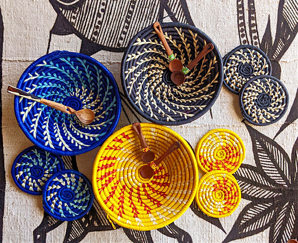 Small woven Raffia African baskets in blue, yellow, and black by Reflektion Design, perfect as wall decor or gift sets.