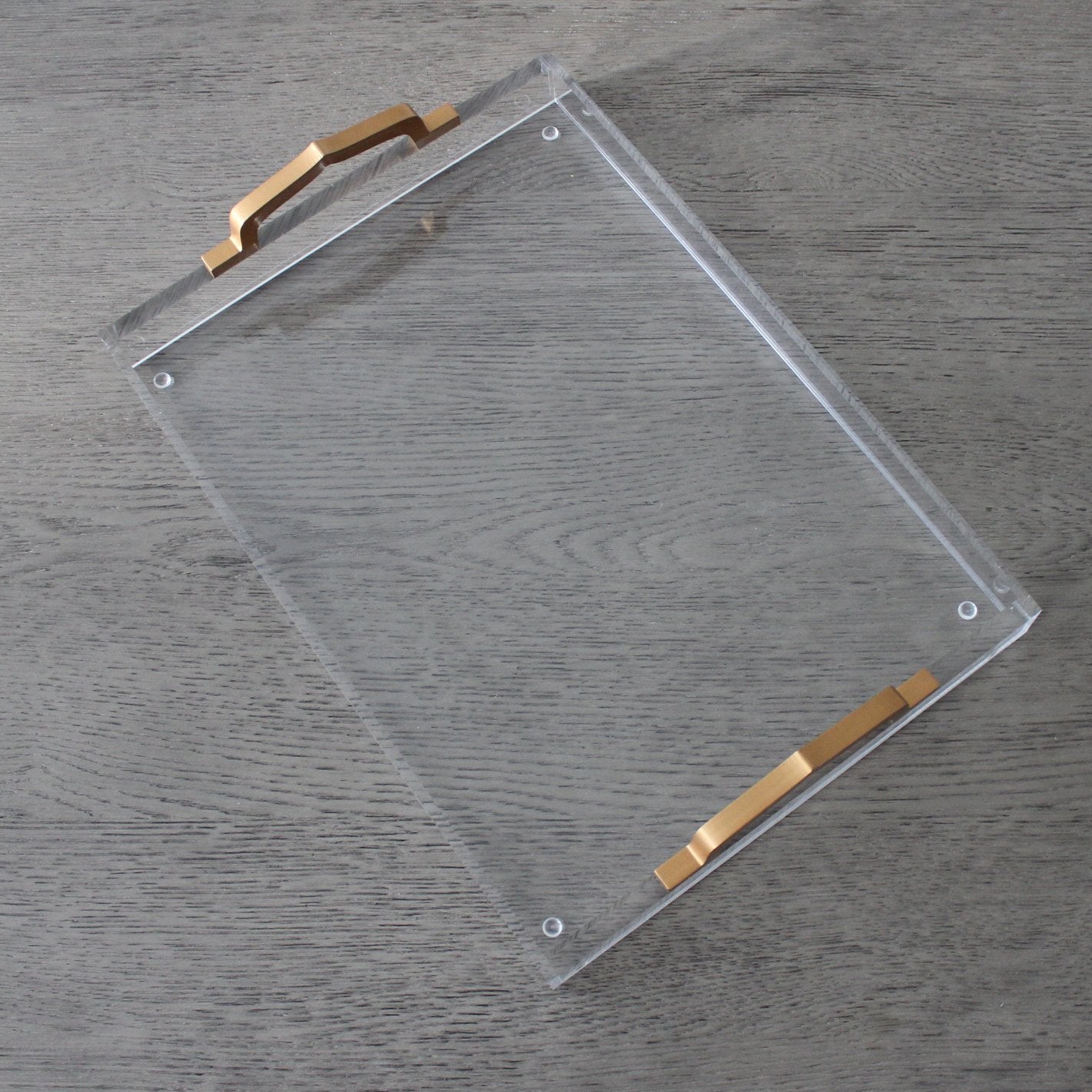 Clear acrylic tray with "Alhambra" branding from Tea + Linen, featuring a sleek rectangular design for serving or display.