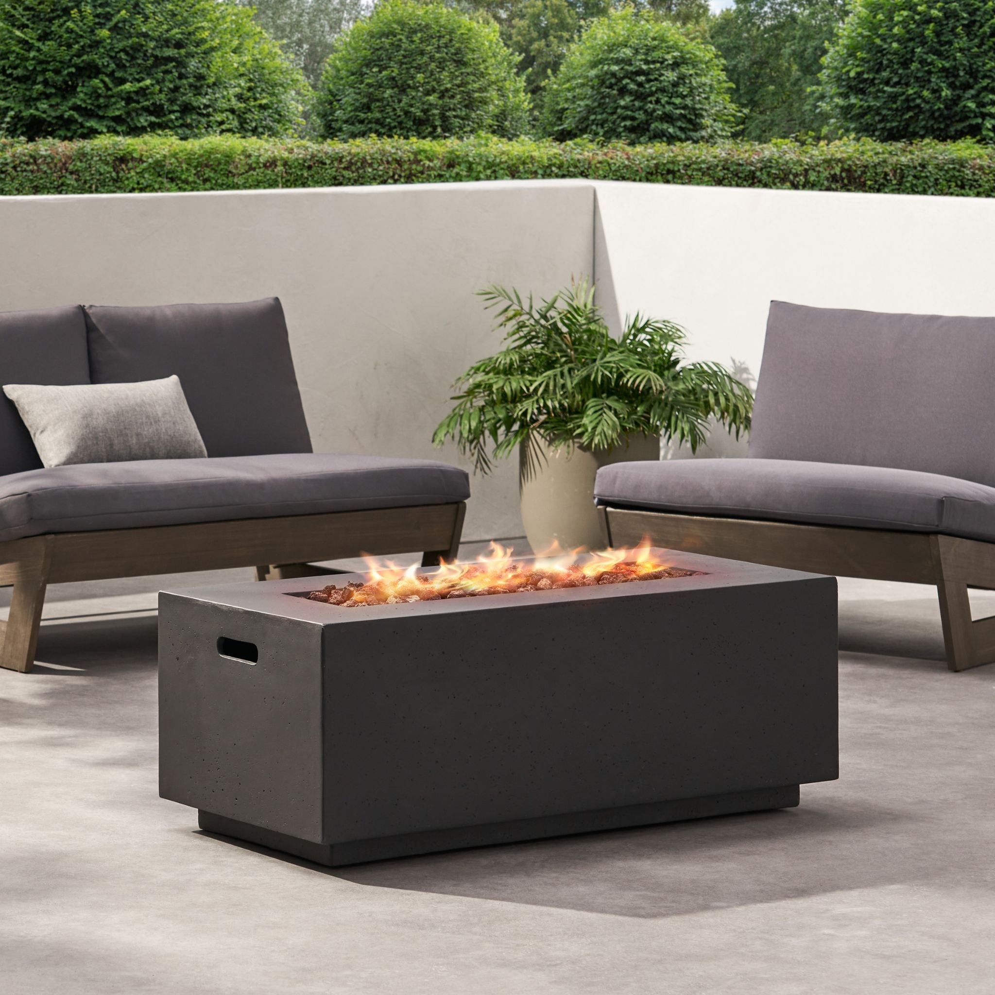 Alora Premium outdoor rectangular propane gas fire pit table with 40K BTU, set up in a backyard for cozy gatherings.