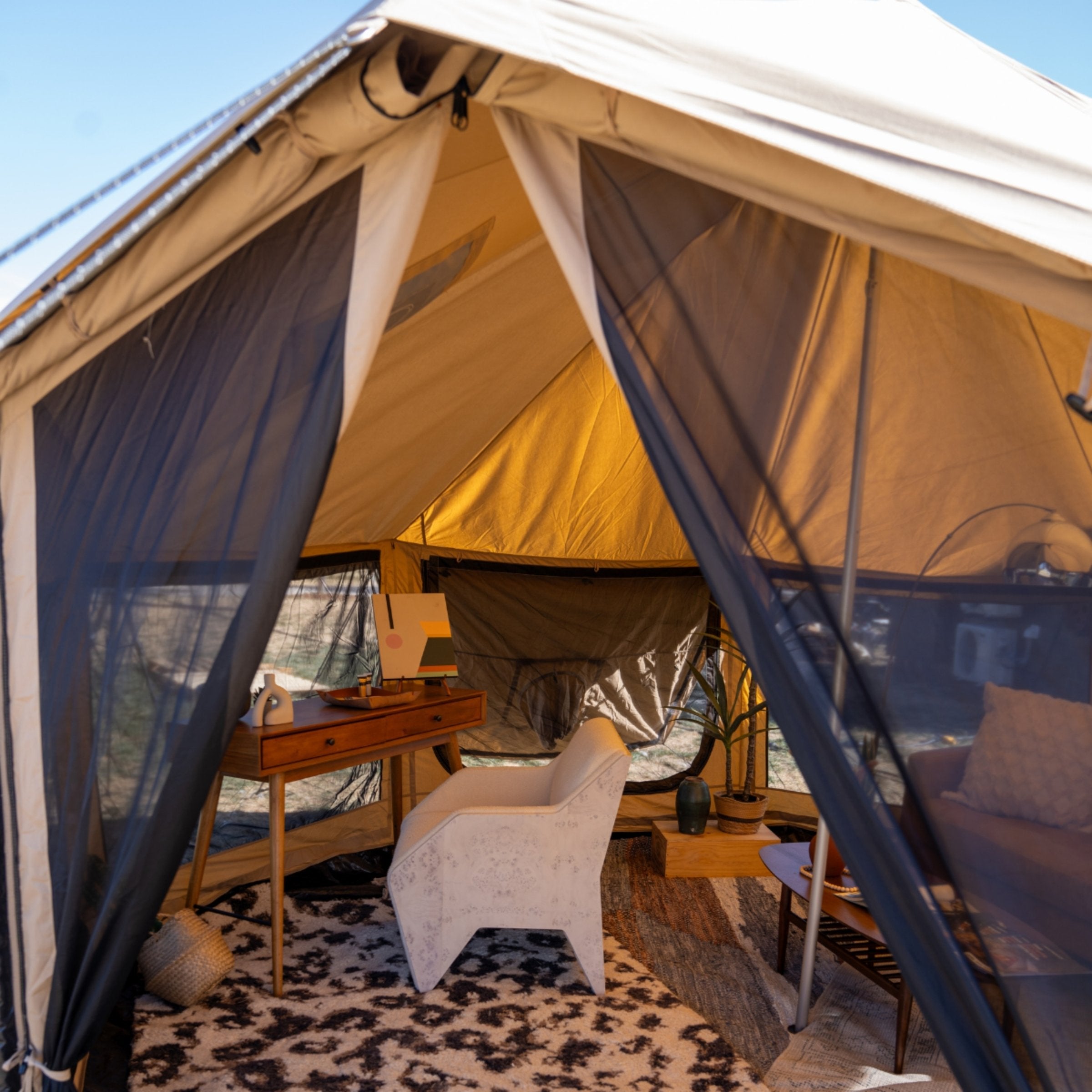 White Duck Outdoors Altimus Bell Tent set up for glamping with a spacious, stylish design in a scenic outdoor setting.