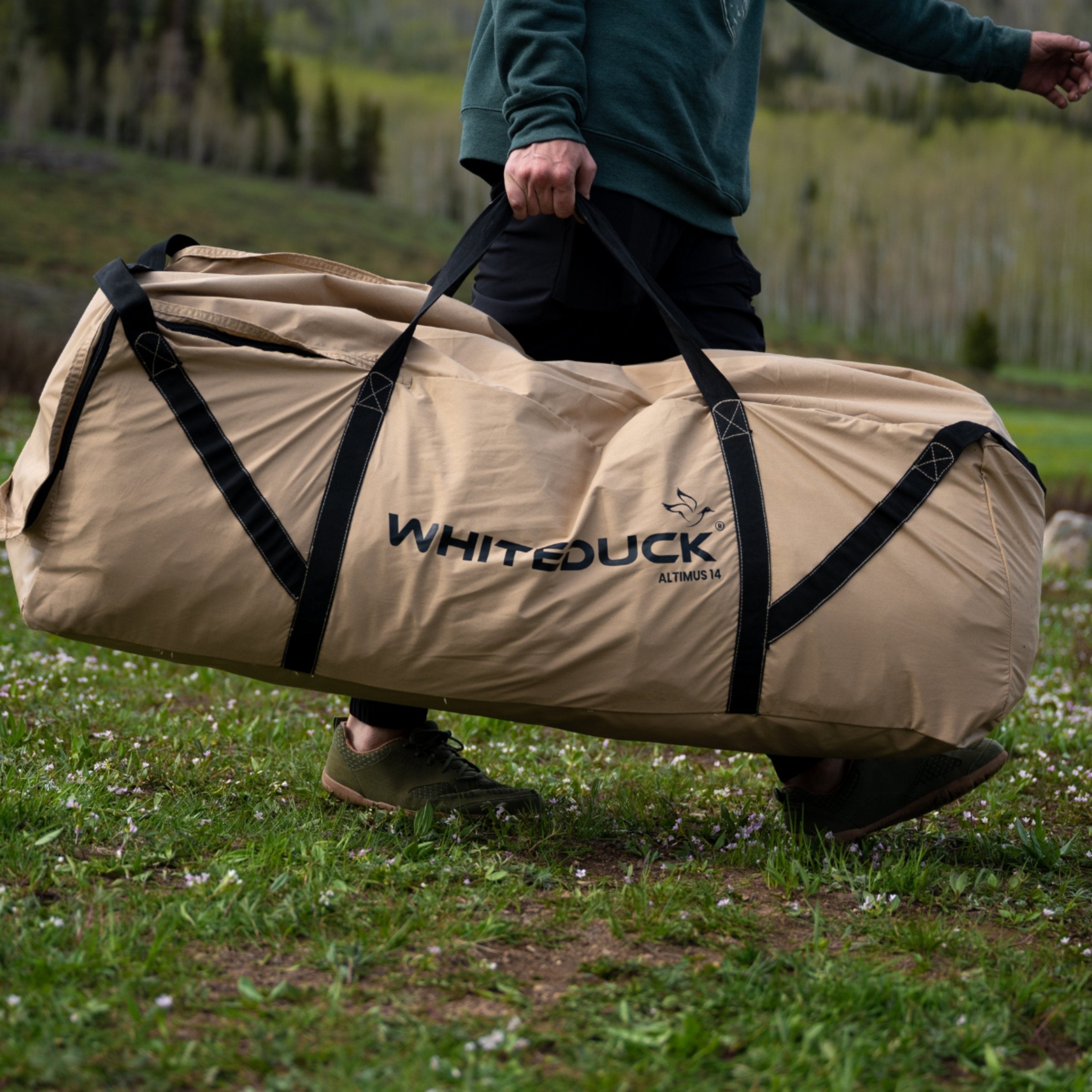 White Duck Outdoors Altimus Bell Tent folded in its carry bag, showcasing portable outdoor camping shelter with sturdy fabric and structure.