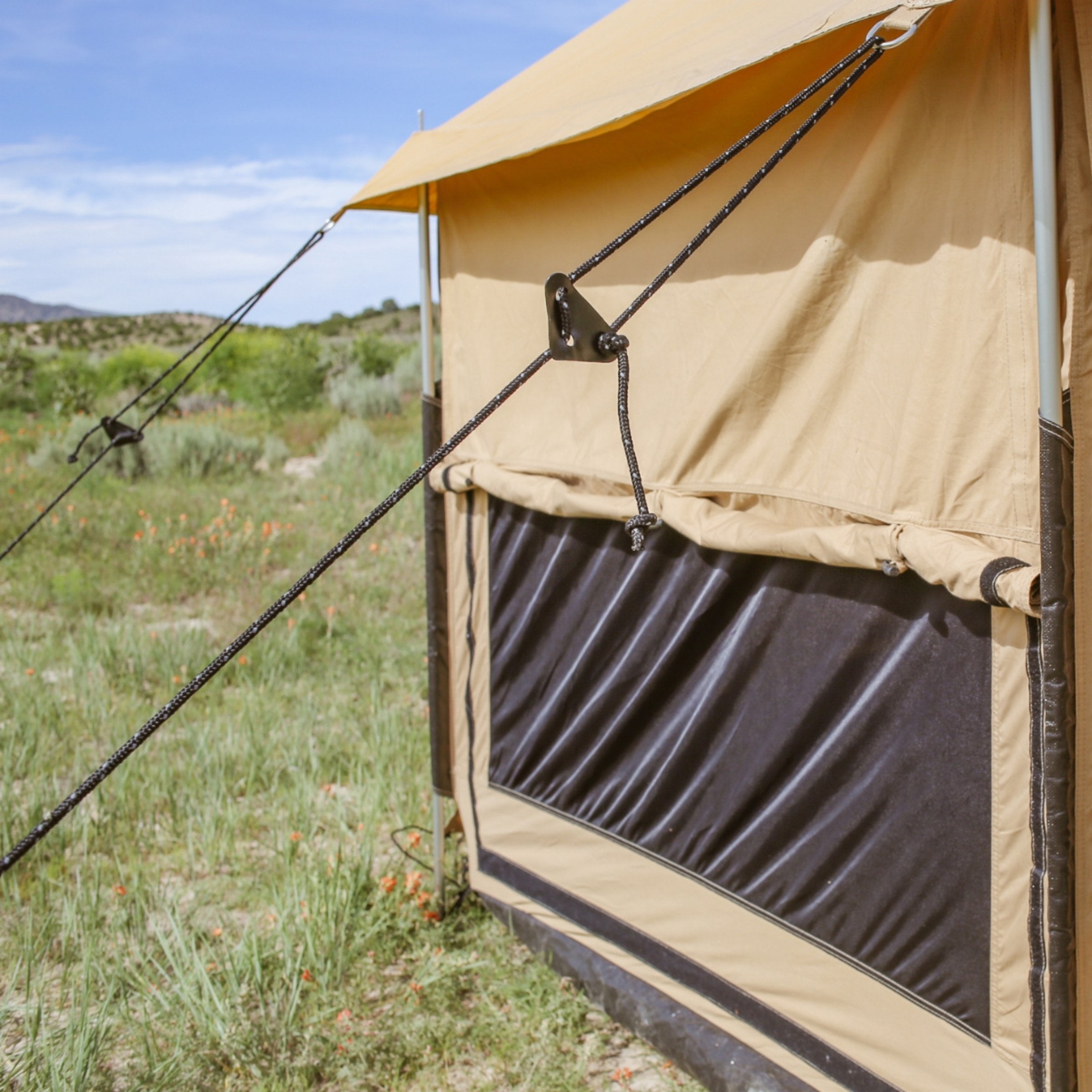 White Duck Outdoors Altimus Bell Tent with partially closed window flap, showcasing its durable canvas and spacious design.