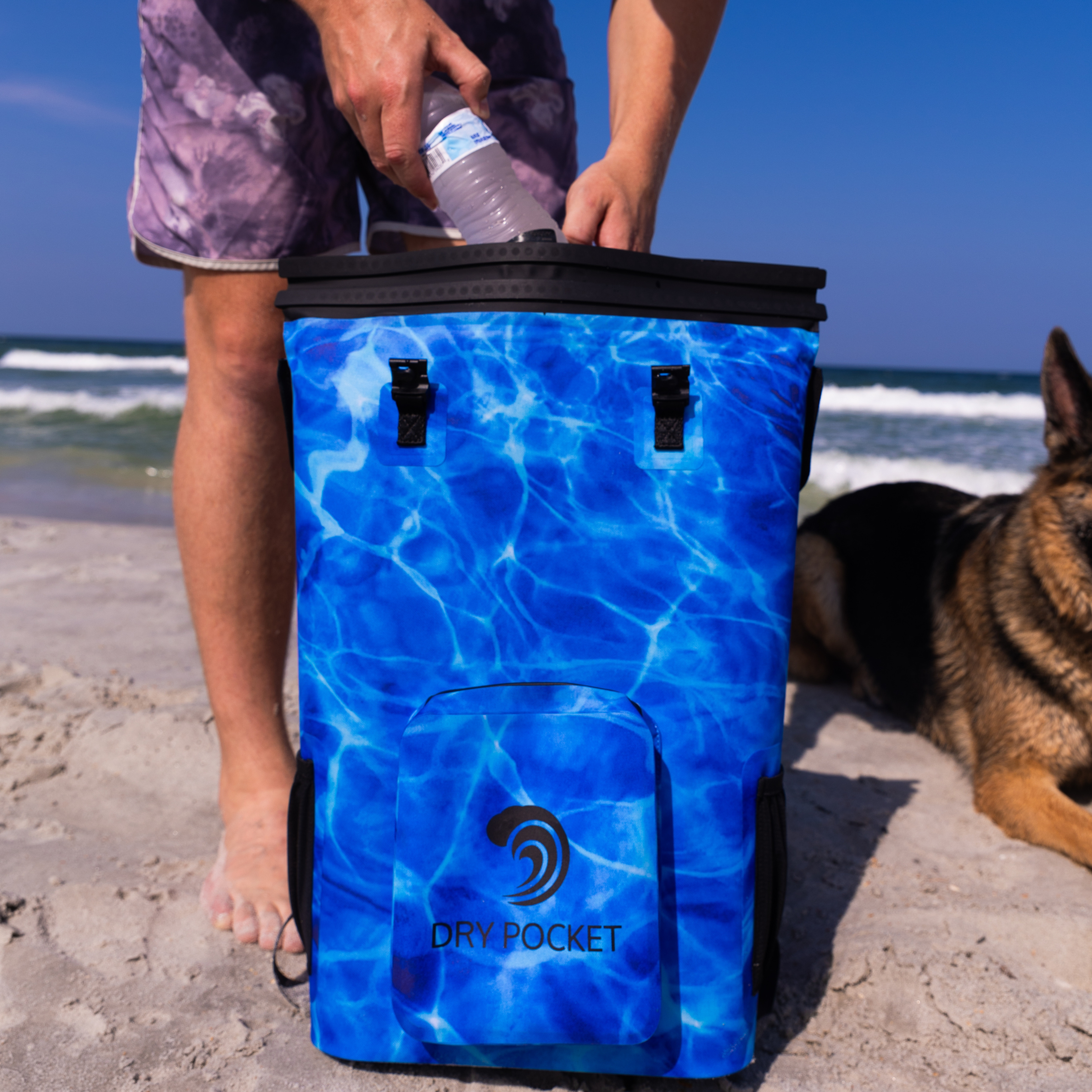Aqua blue Dry Pocket waterproof floating backpack cooler with adjustable straps and multiple compartments for outdoor adventures.