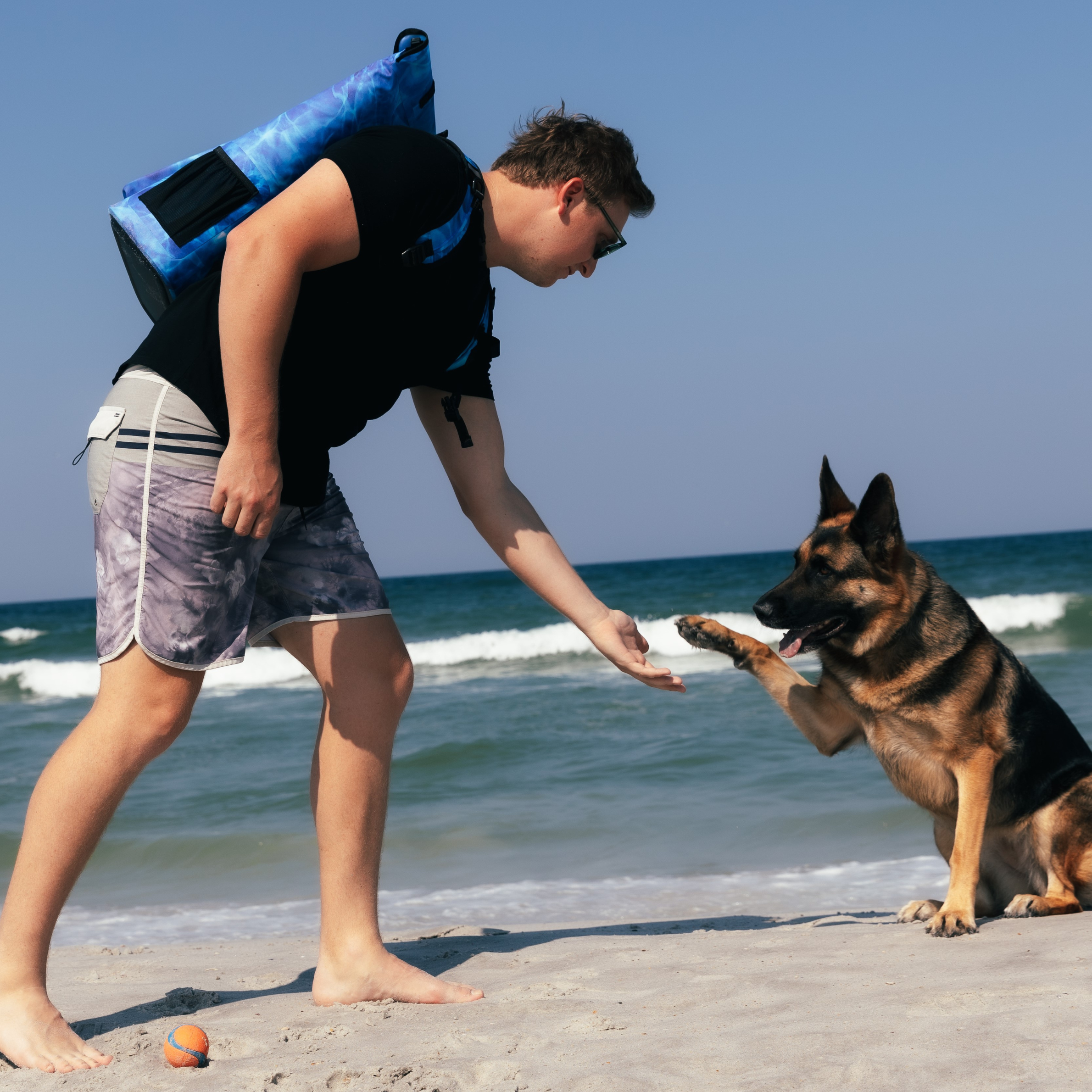Aqua blue Dry Pocket waterproof floating backpack cooler with adjustable straps and multiple compartments for outdoor use.