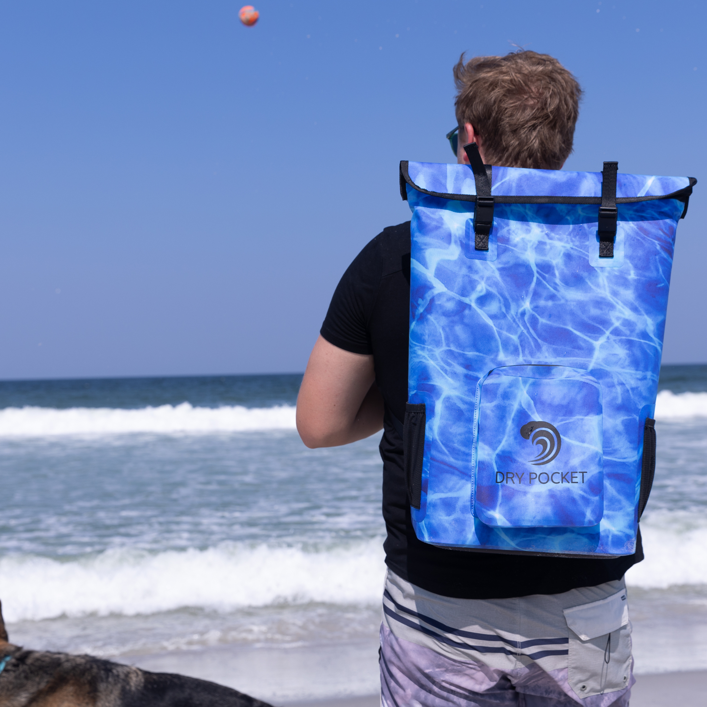 Aqua blue Dry Pocket waterproof floating backpack cooler with adjustable straps and multiple compartments for outdoor use.