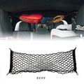 Toyota Tacoma attic storage net by Flatirons Overland, shown installed in the vehicle's attic space for secure storage.