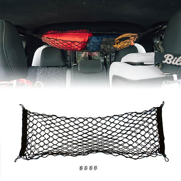 Toyota Tacoma attic storage net by Flatirons Overland, shown installed in the vehicle's attic space for secure storage.