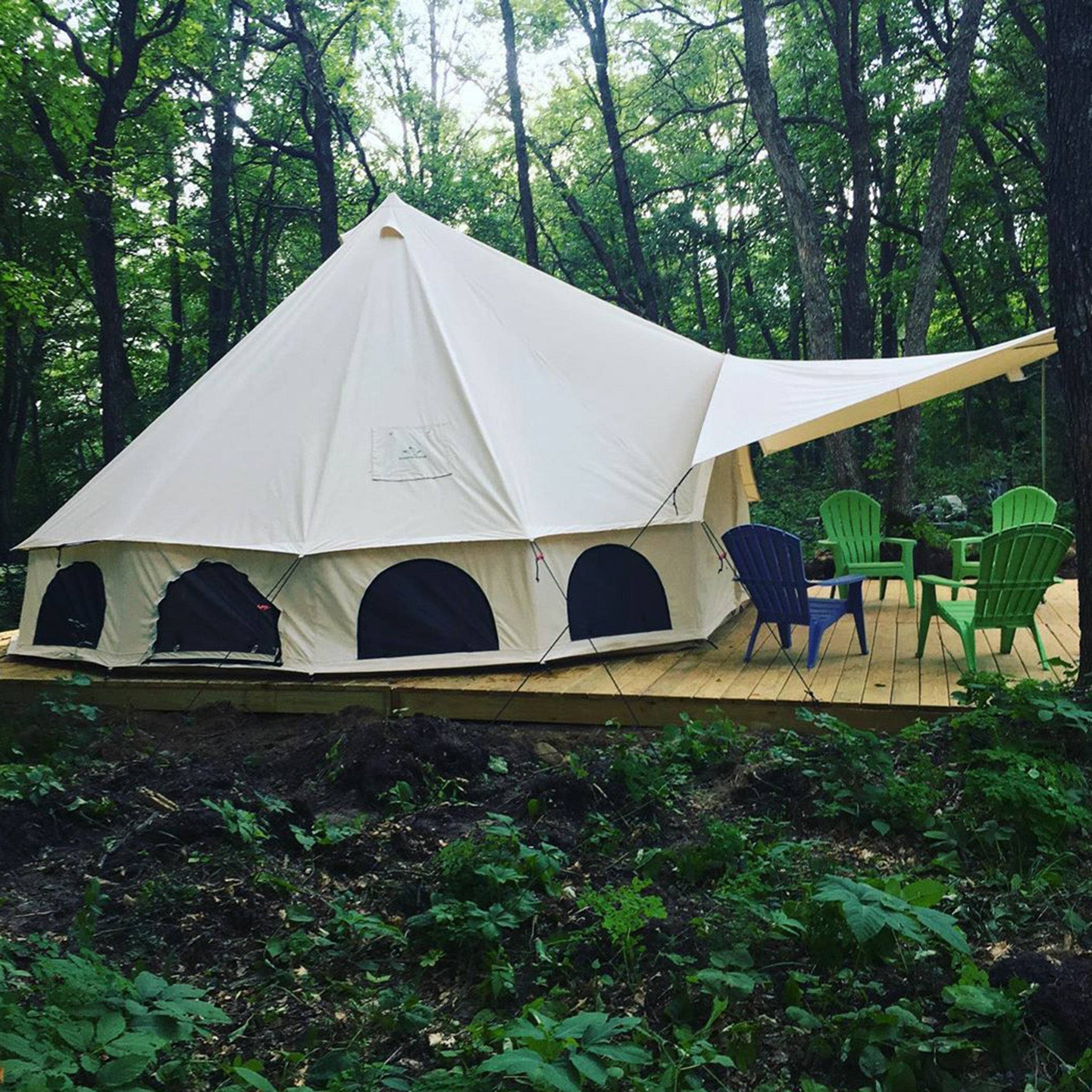 White Duck Outdoors Avalon bell tent awning set up on platform, providing extra shade and shelter for outdoor camping.
