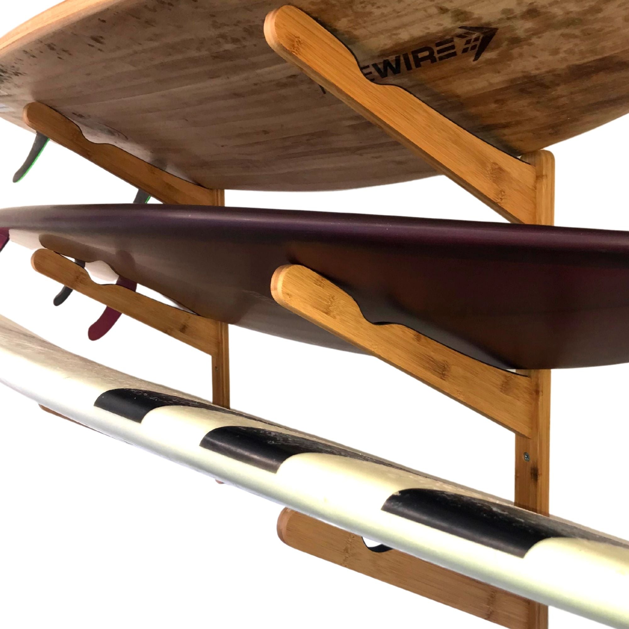 Close-up of COR Surf bamboo triple surfboard wall rack holding surfboards, wakeboards, and snowboards for organized storage.
