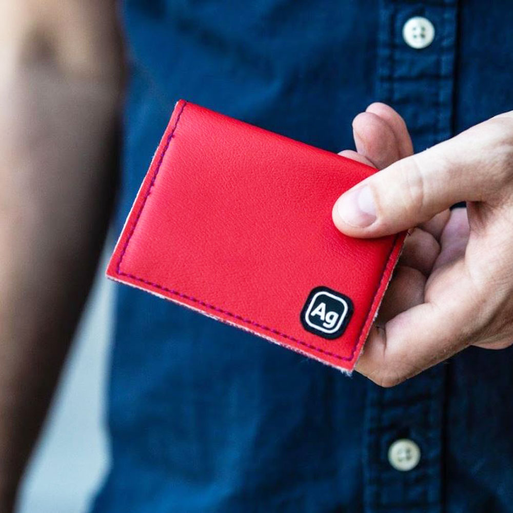 Red Alchemy Goods Belltown Wallet with vinyl upholstery, compact wallet design from ZEITBIKE, showcasing interior compartments.