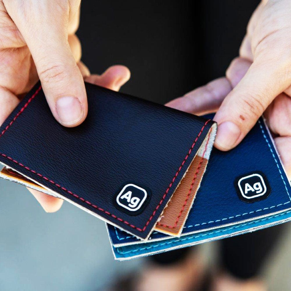 ZEITBIKE Alchemy Goods Belltown Wallet with vinyl upholstery held in hands, showcasing slim, durable wallet design.