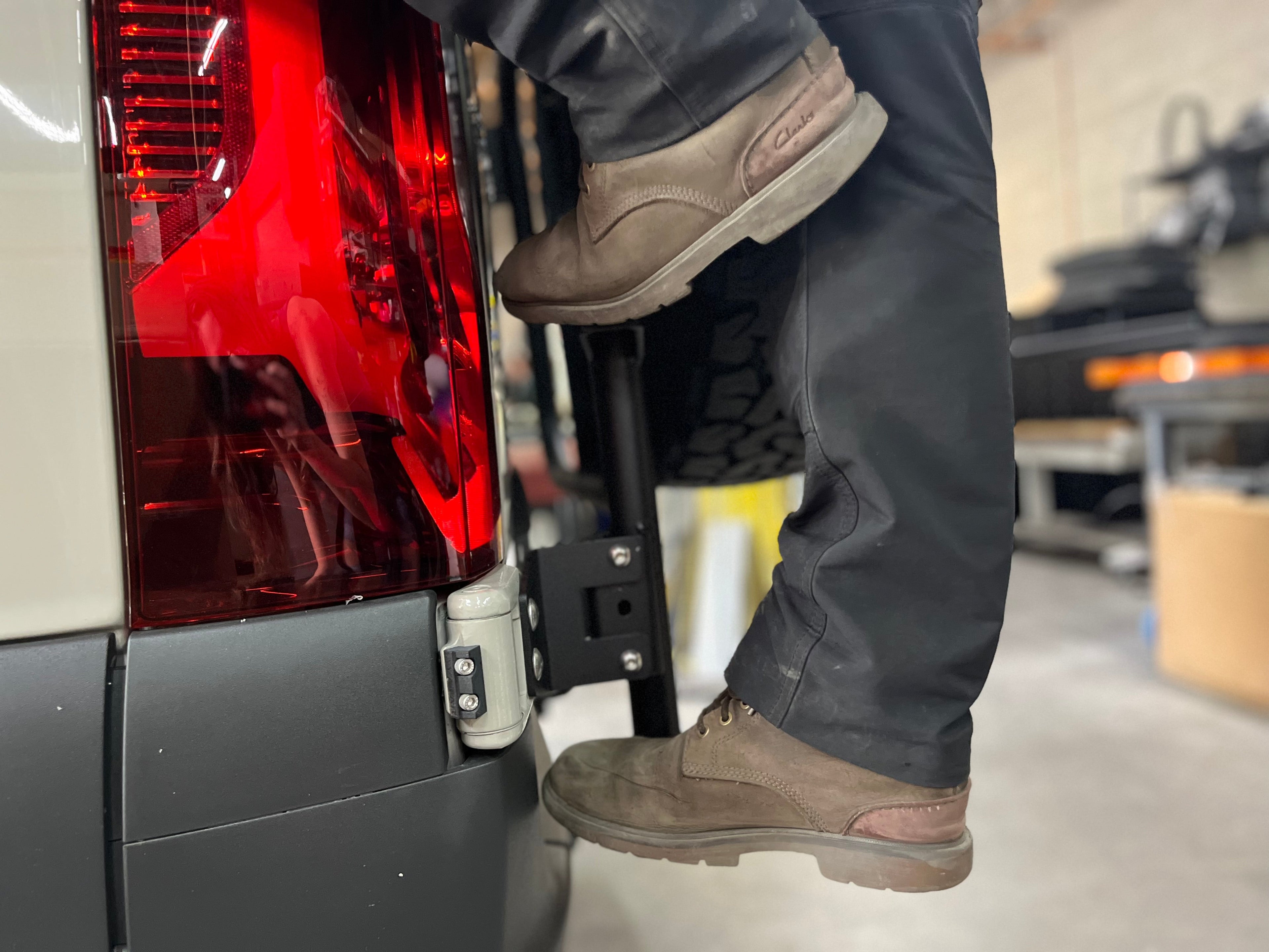 Offroad rear ladder tire carrier mount by Avatar Offroad attached to a vehicle for easy access to spare tire.
