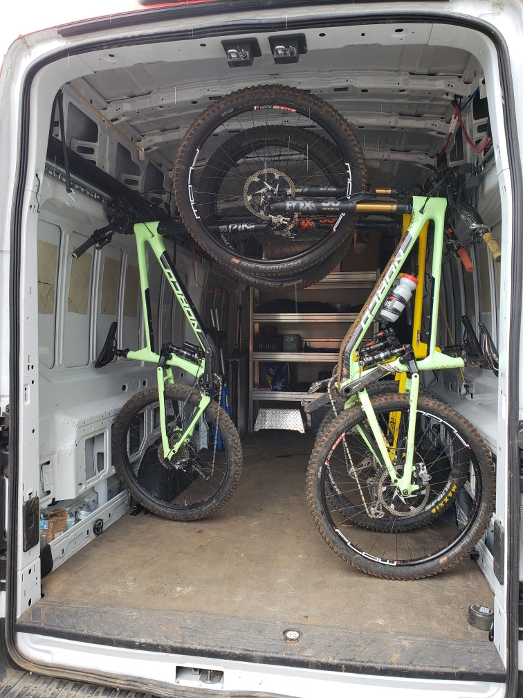 Lolo Racks L-track compatible single bike carrier hanging inside a van or trailer, showcasing easy bike transportation accessory.