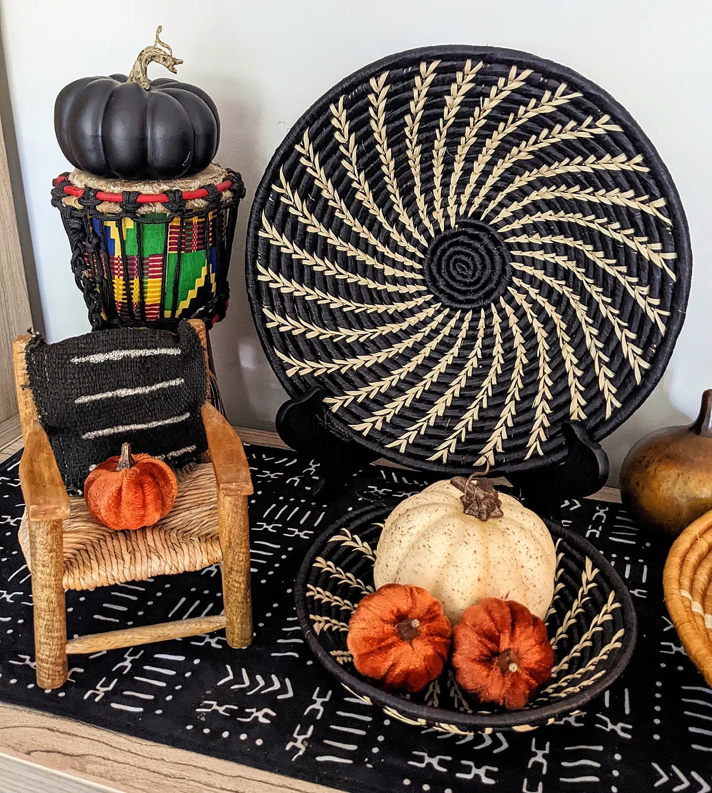 Large black and white woven African wall basket by Reflektion Design, featuring intricate woven patterns and a circular shape.