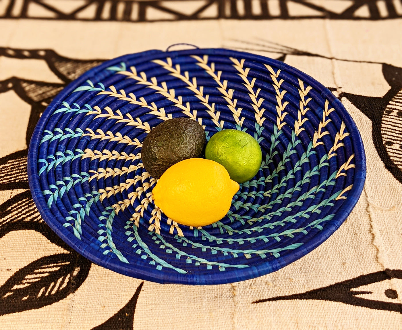 Large blue and white woven African basket by Reflektion Design with intricate patterns and sturdy handles.