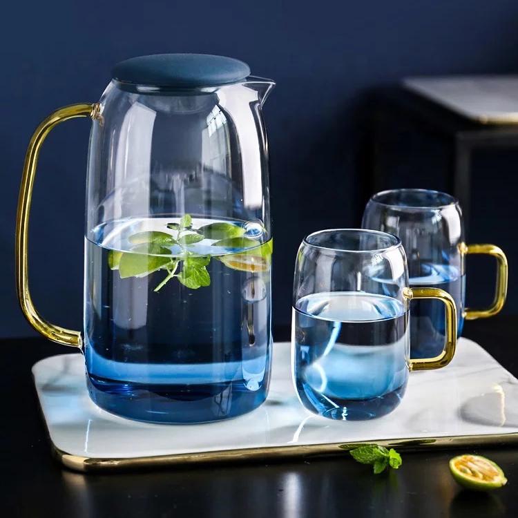 Blue ombre glass pitcher and cups set by Tea + Linen, showcasing a gradient design in a vibrant blue color.