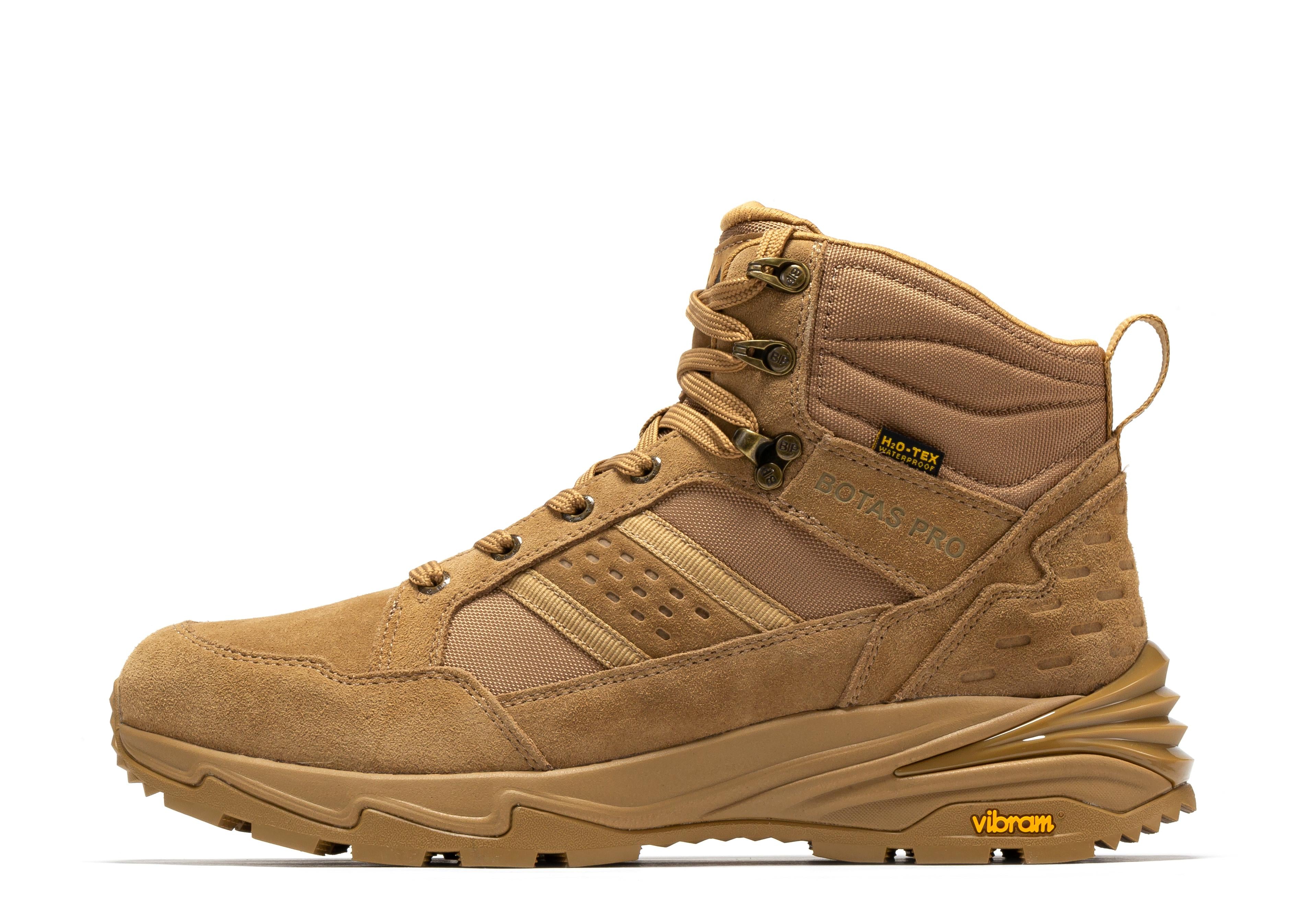 Rock Rooster Pro Sand 6-inch waterproof tactical hiking boots with VIBRAM® traction lug outsole on rugged terrain.