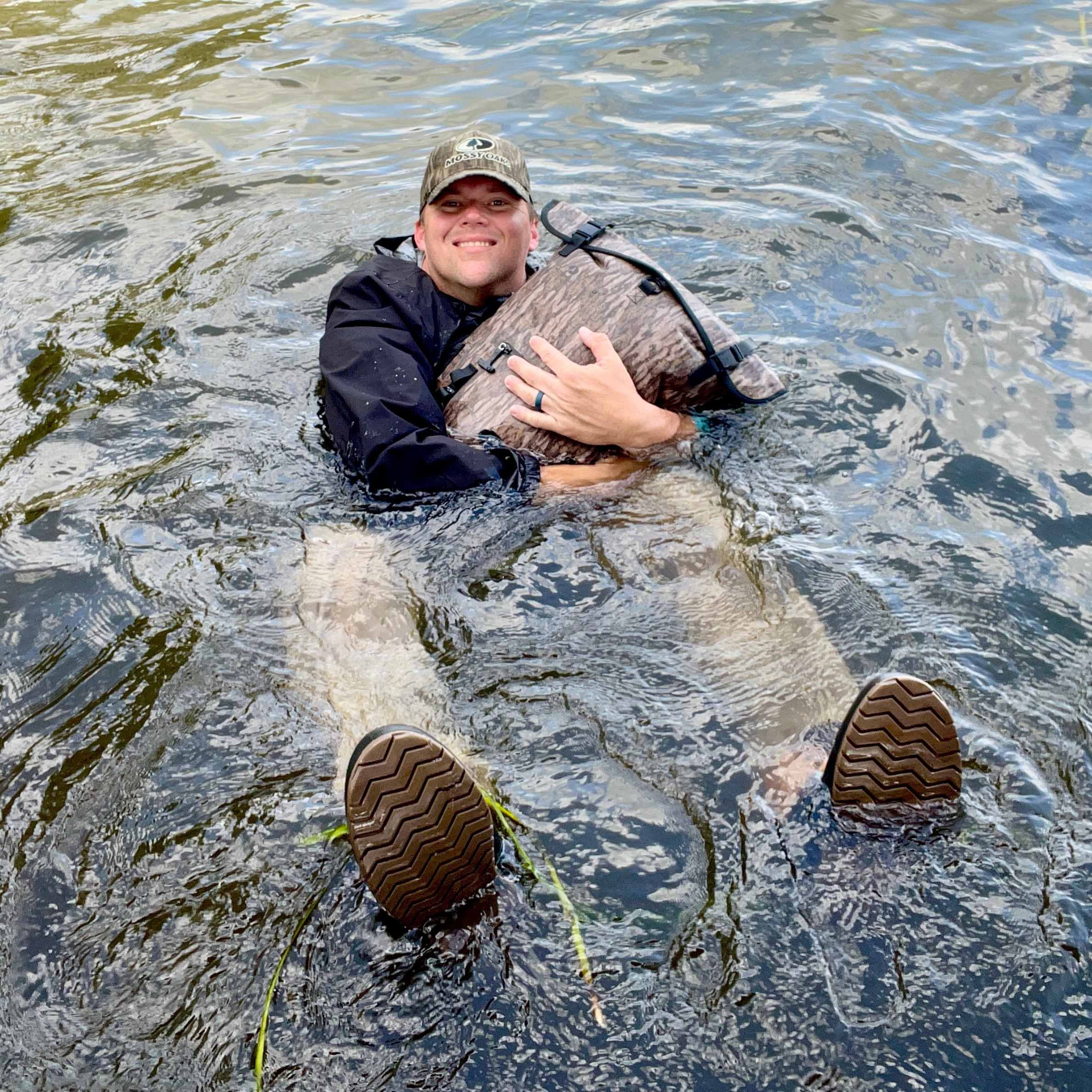 Waterproof Dry Pocket floating backpack dry bag in bottomland camouflage, designed for water activities and outdoor adventures.
