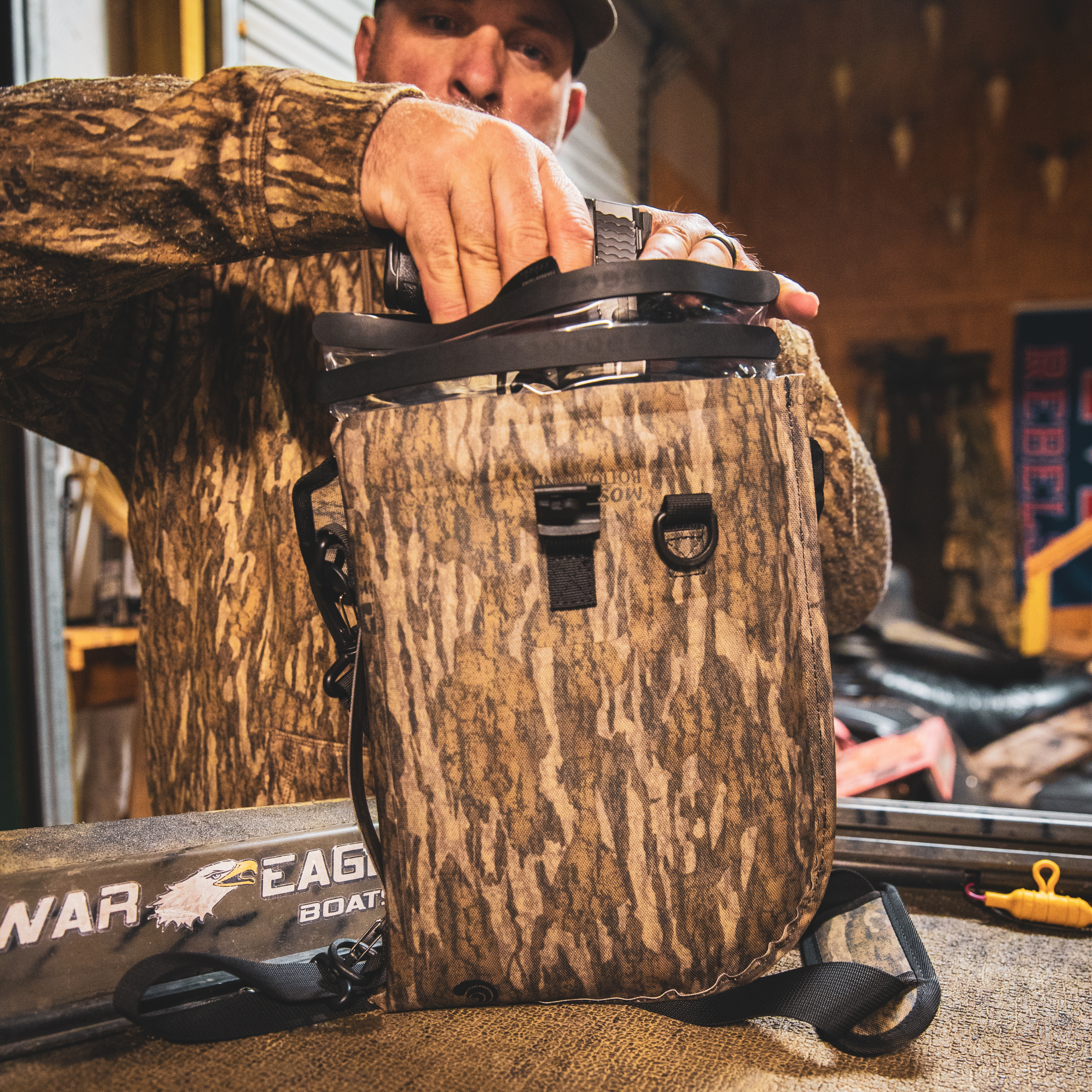 Dry Pocket waterproof floating pistol bag with auto-sealing design, shown in bottomland camouflage for secure firearm protection.