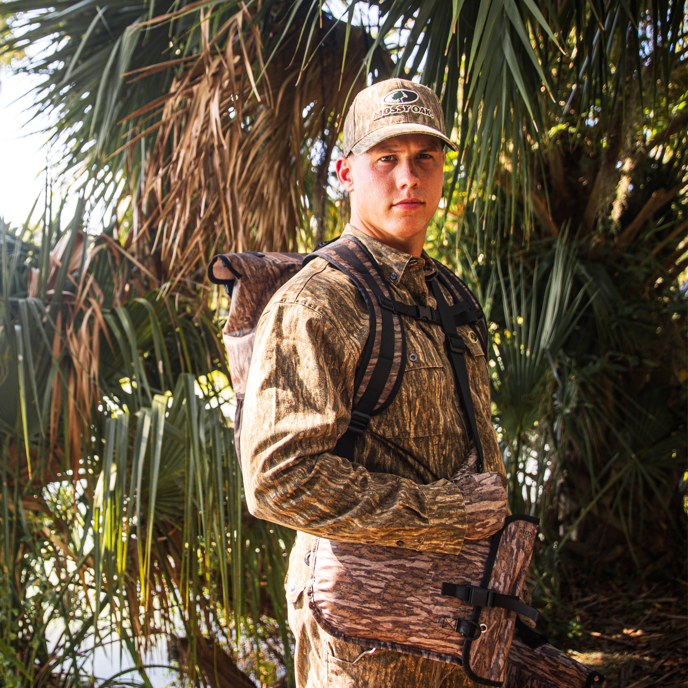 Auto-sealing waterproof floating pistol bag by Dry Pocket, with bottomland camouflage design and secure closure for firearm protection.