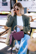 Burgundy semi-circle Margo Paige crossbody handbag with adjustable strap and gold-tone hardware, stylish and compact.