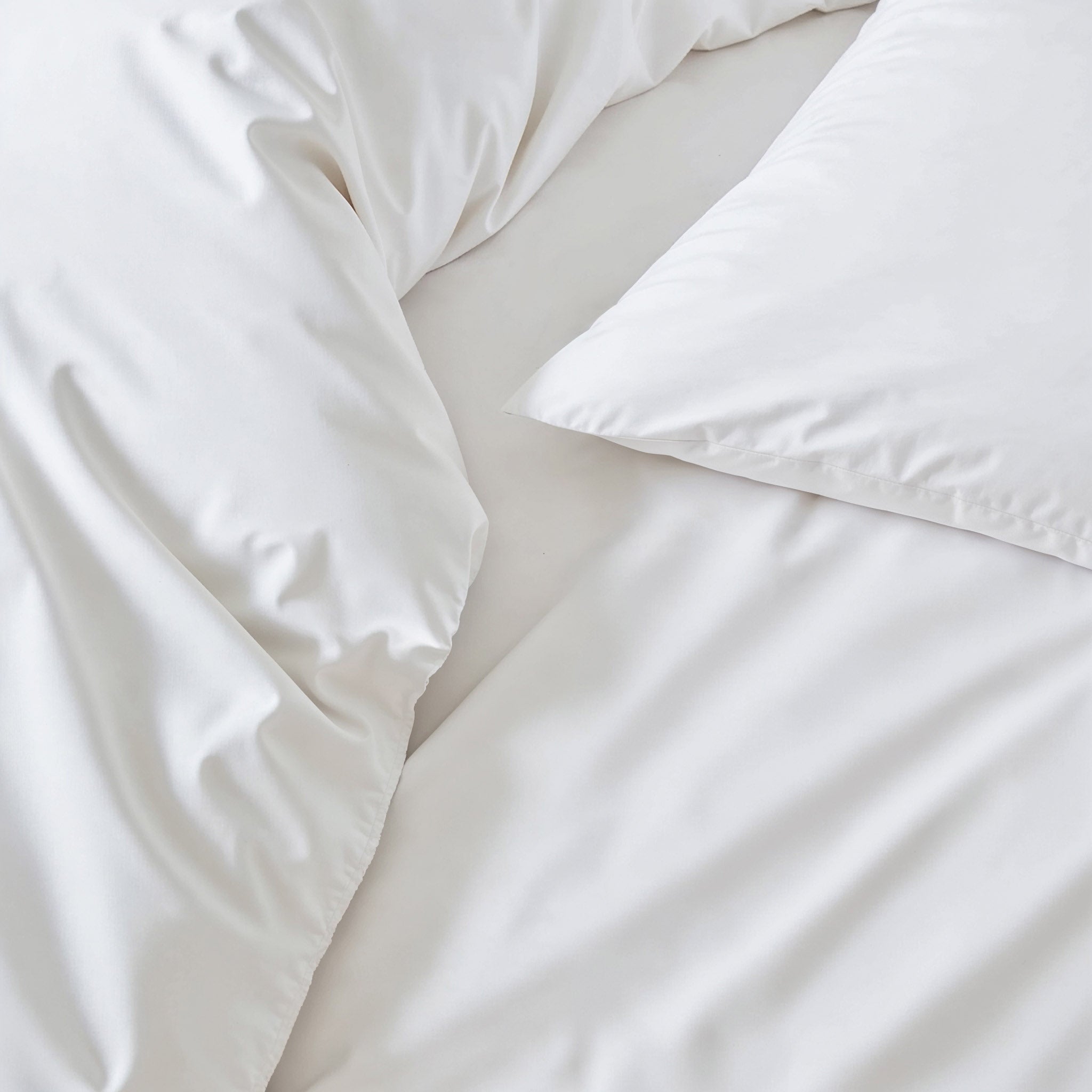 Italic Luxe Australian Sateen Duvet Cover on a bed, showcasing smooth, glossy fabric and elegant design for a luxurious bedroom look.