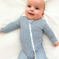 Basically Soho Miami Cabana Stripe Zippered Romper, featuring vibrant striped fabric and a front zipper, perfect for summer wear.
