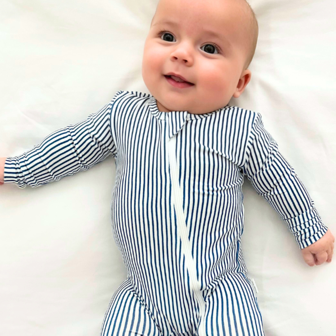 Basically Soho Miami Cabana Stripe Zippered Romper, featuring vibrant striped fabric and a front zipper, perfect for summer wear.