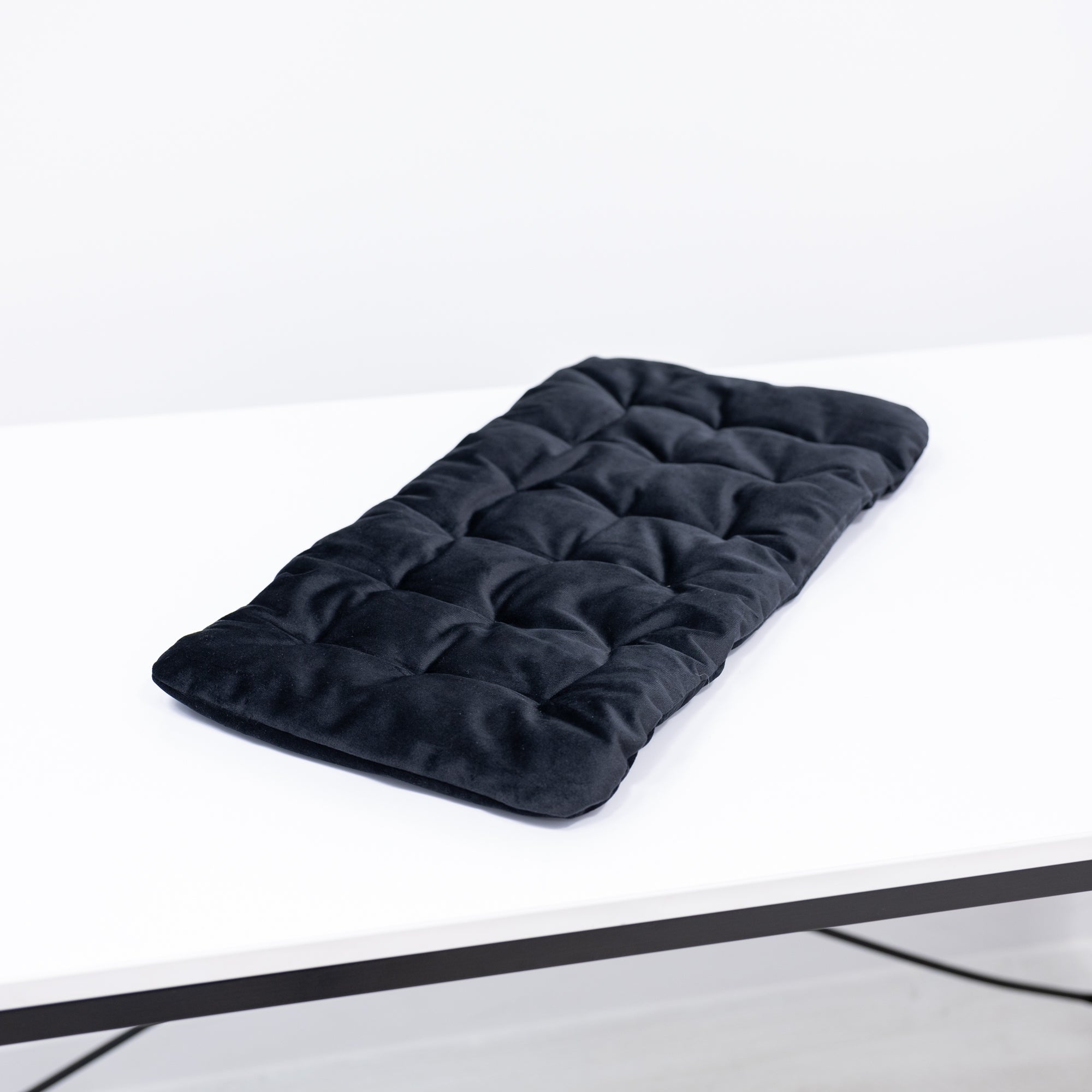 Black sleeping cat-shaped pillow from Enjoy The Wood, designed as a cozy bed pillow for relaxation and comfort.